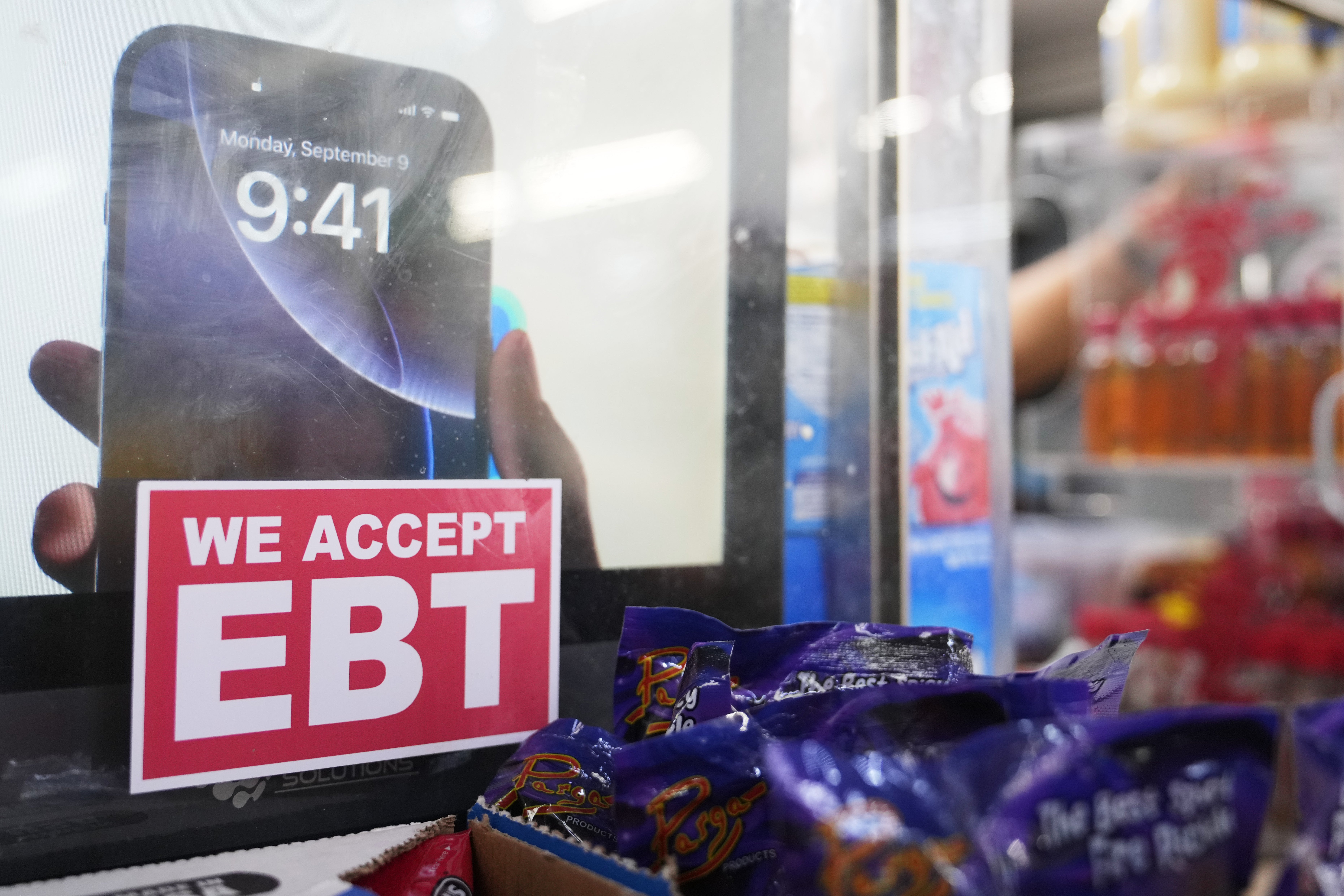 A sign is displayed for EBT for the USDA Supplemental Nutrition Assistance Program (SNAP) at the Friend's Meat Market and Grocery, Friday, Nov. 14, 2025, in Miami