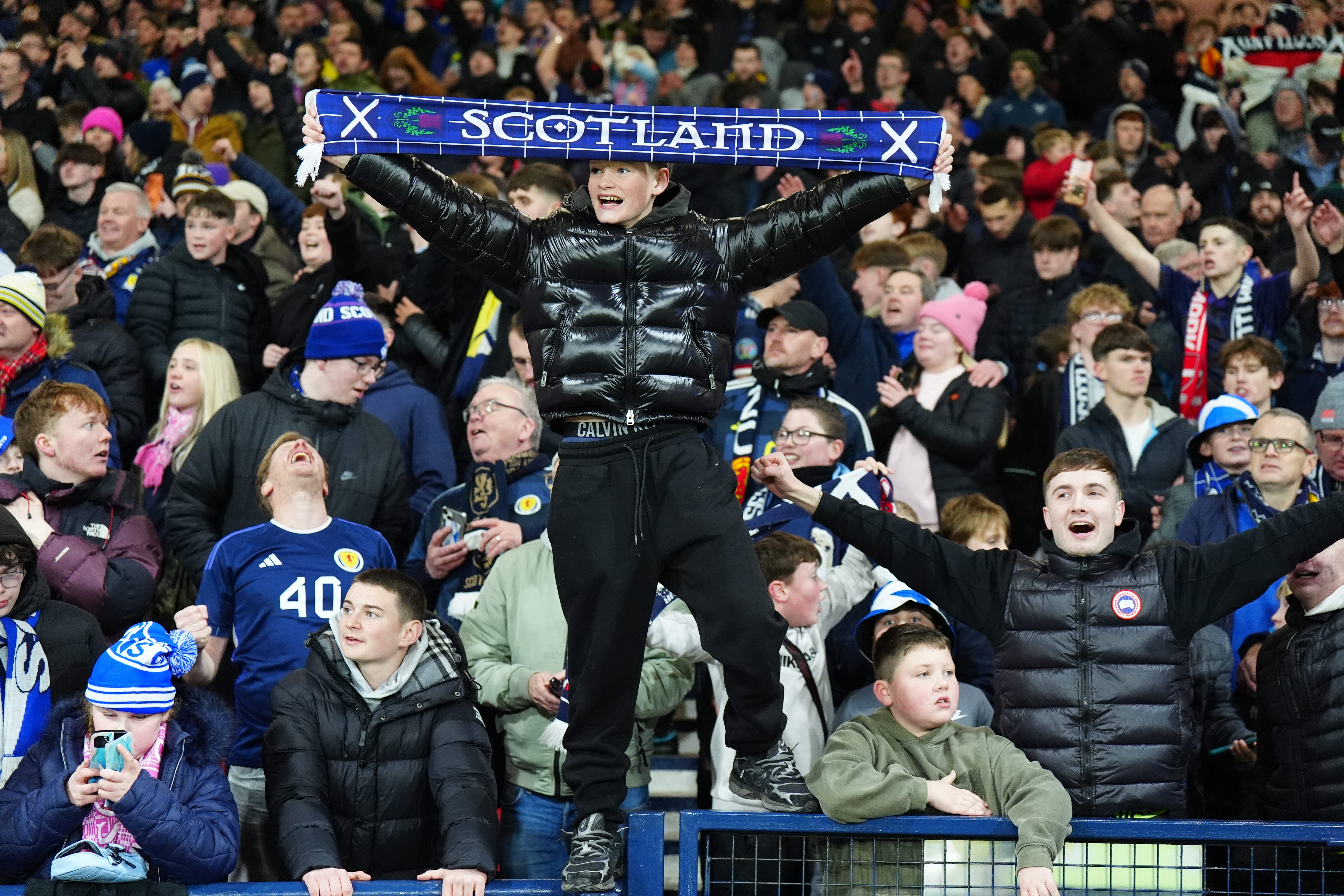 Scotland fans celebrate after they qualified for the 2026 World Cup (Jane Barlow/PA)