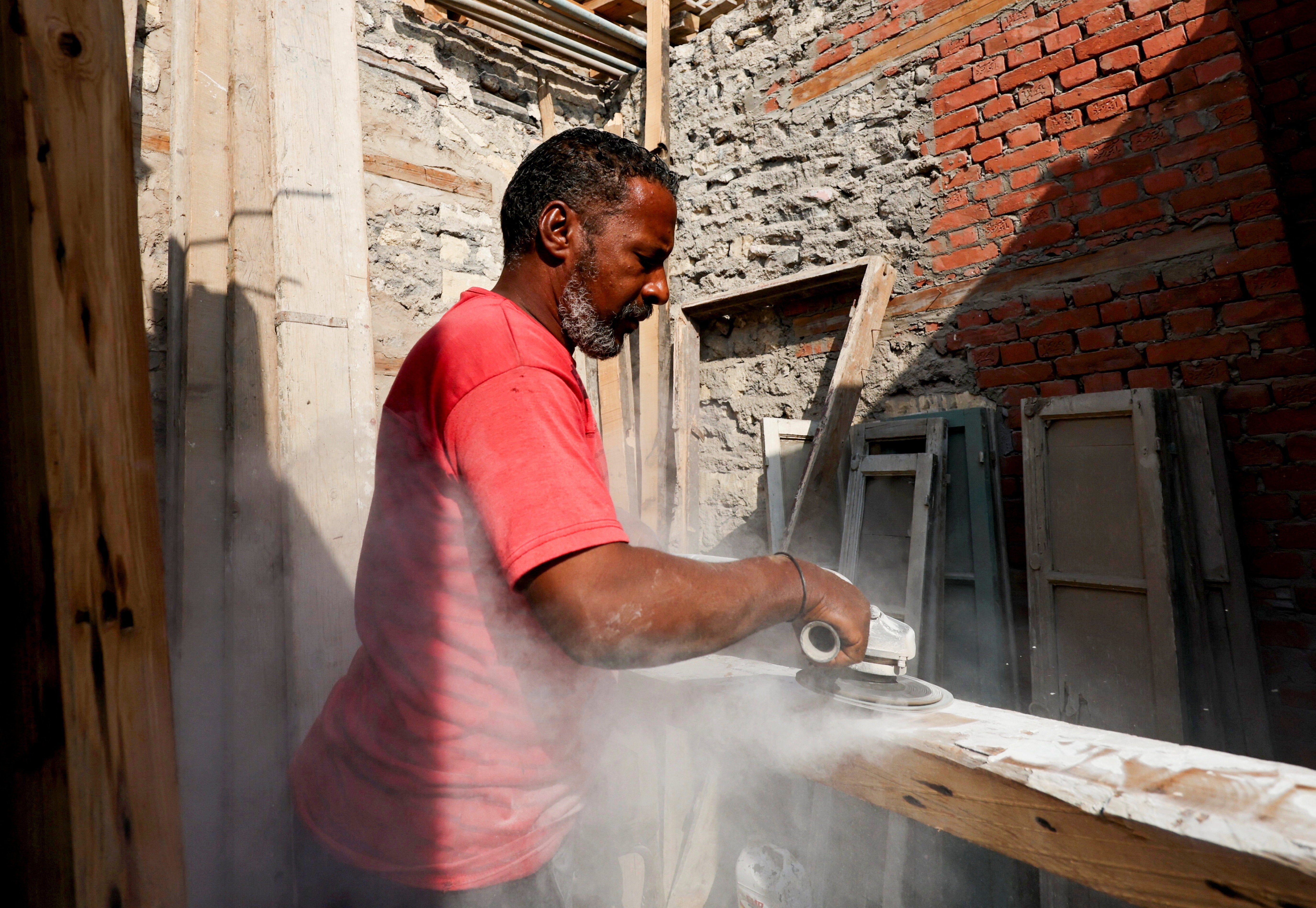 <p>An Egyptian man works on-site at the Darb al-Labbana restoration project, designed to rebuild the historic yet dilapidated neighborhood in old Cairo, Egypt</p>