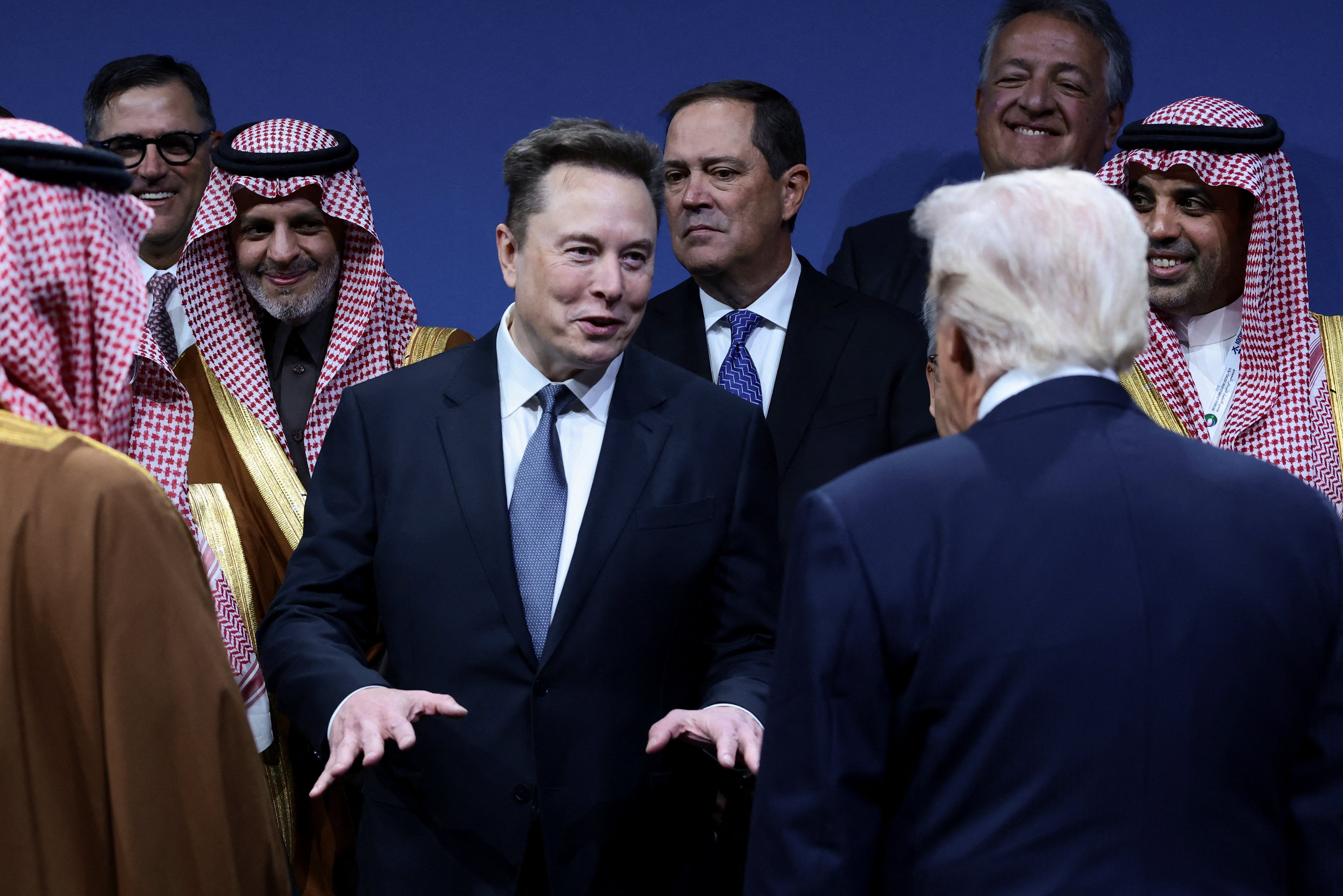 U.S. President Donald Trump and Elon Musk interact during the U.S.-Saudi Investment Forum in Washington, D.C., U.S., November 19, 2025. REUTERS/Evelyn Hockstein