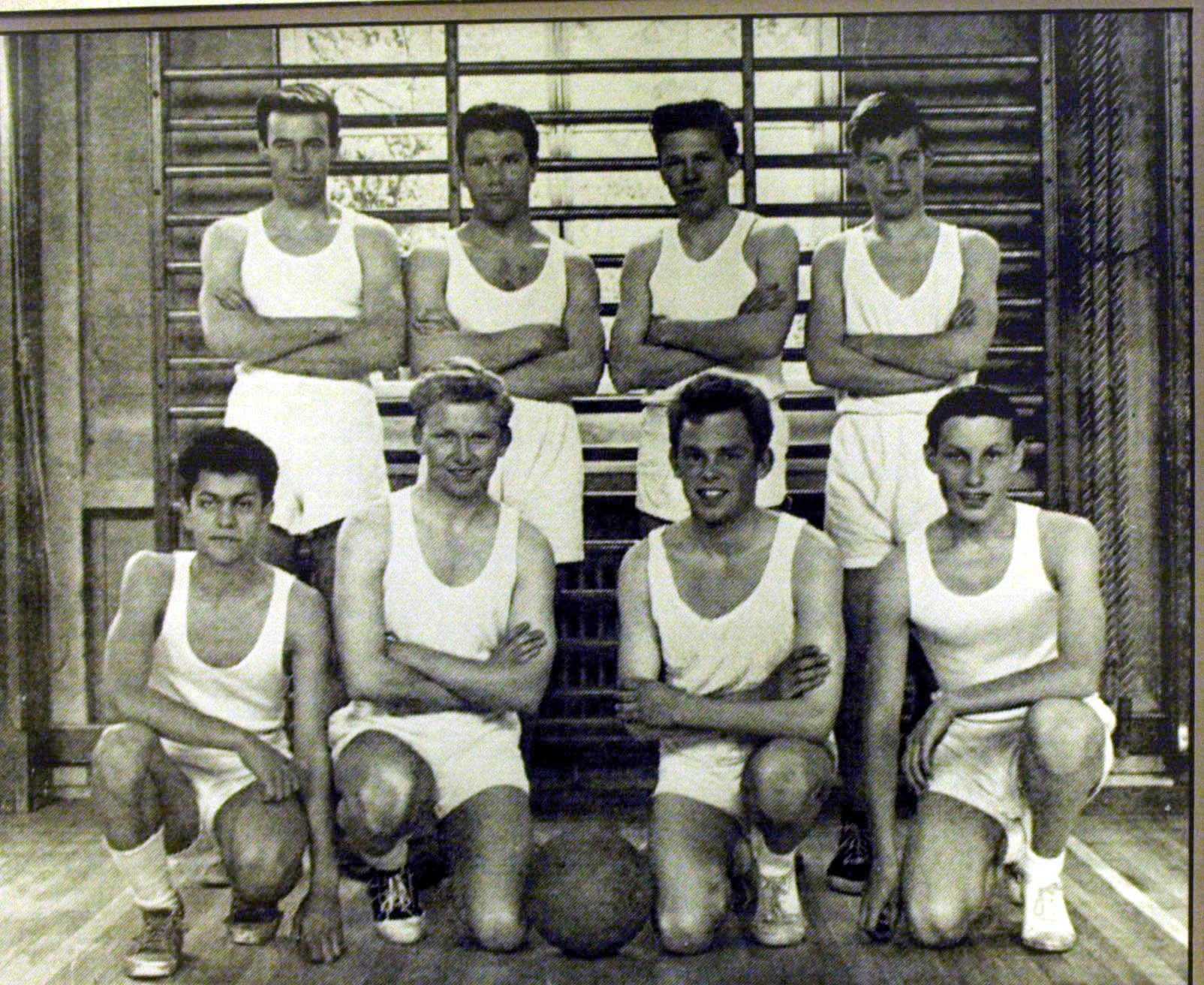 Black and white image of Mick Jagger (back row, far right) in the school basketball team at Dartford Grammar School, Kent, which he left in 1961