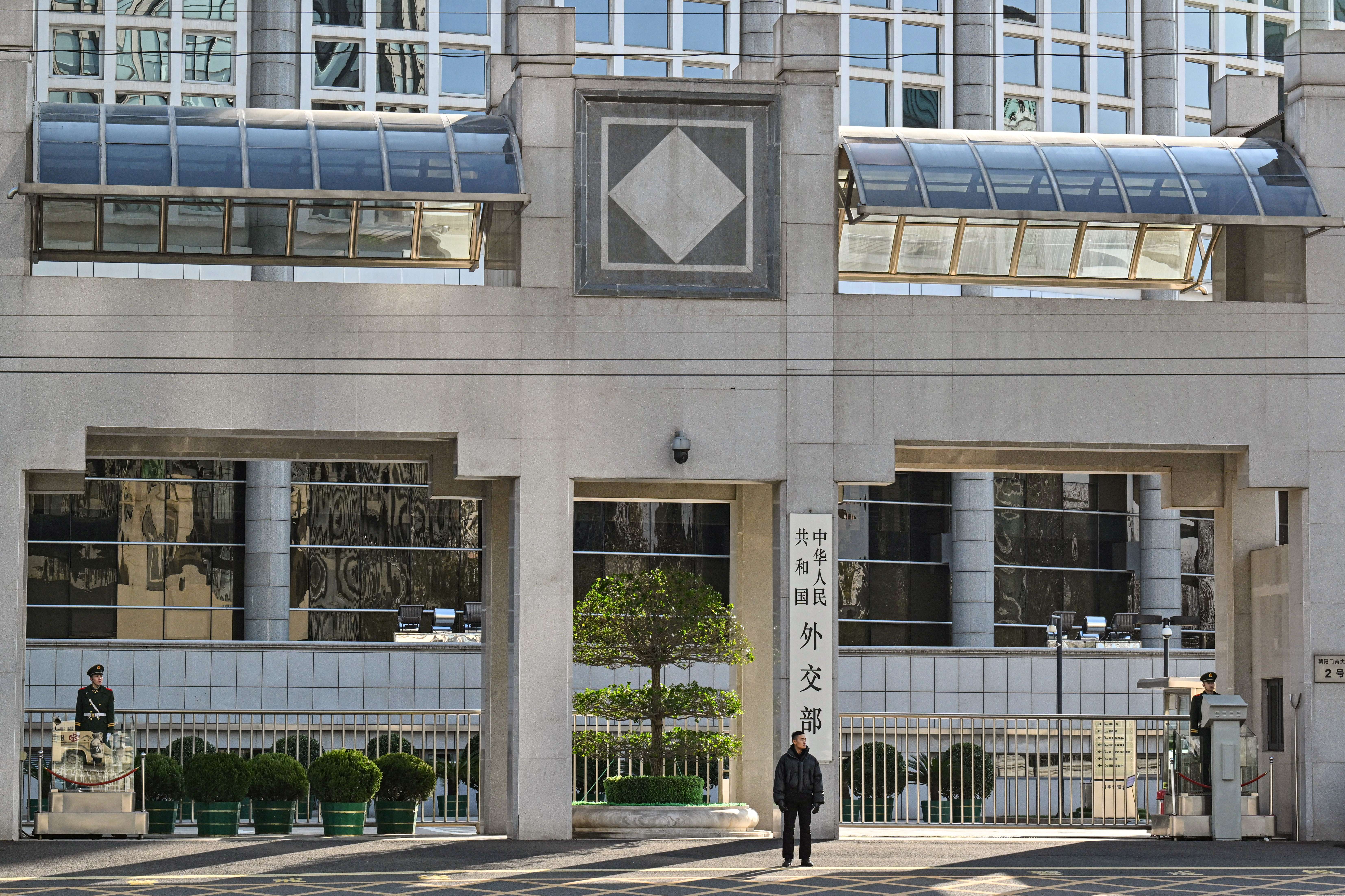 Security personnel stand guard outside the foreign ministry in Beijing