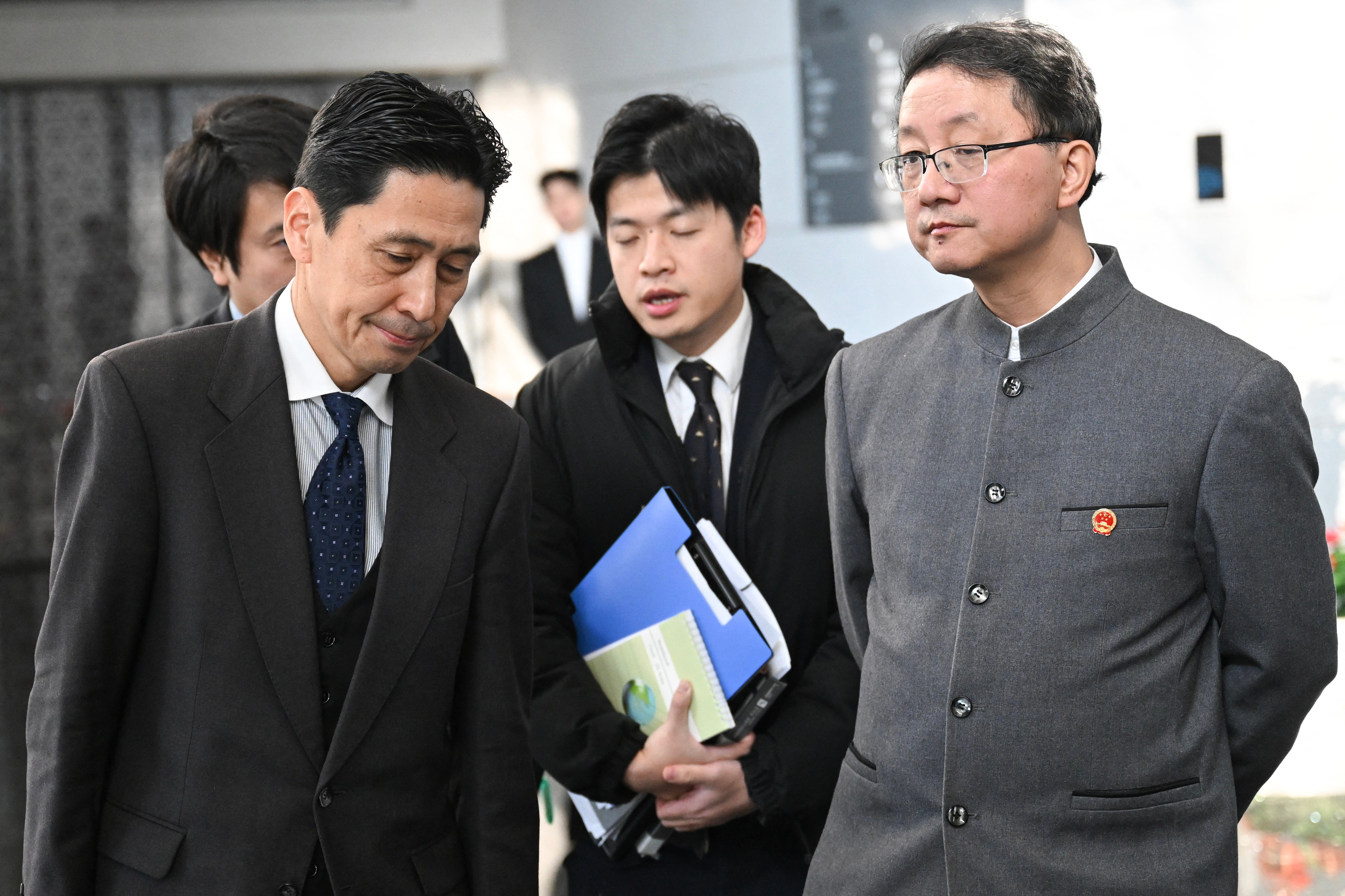 Japanese director-general of the foreign ministry's Asian and Oceanian affairs bureau Masaaki Kanai (L) and Chinese director-general of the department of Asian affairs Liu Jinsong (C) depart after a meeting at the foreign ministry in Beijing