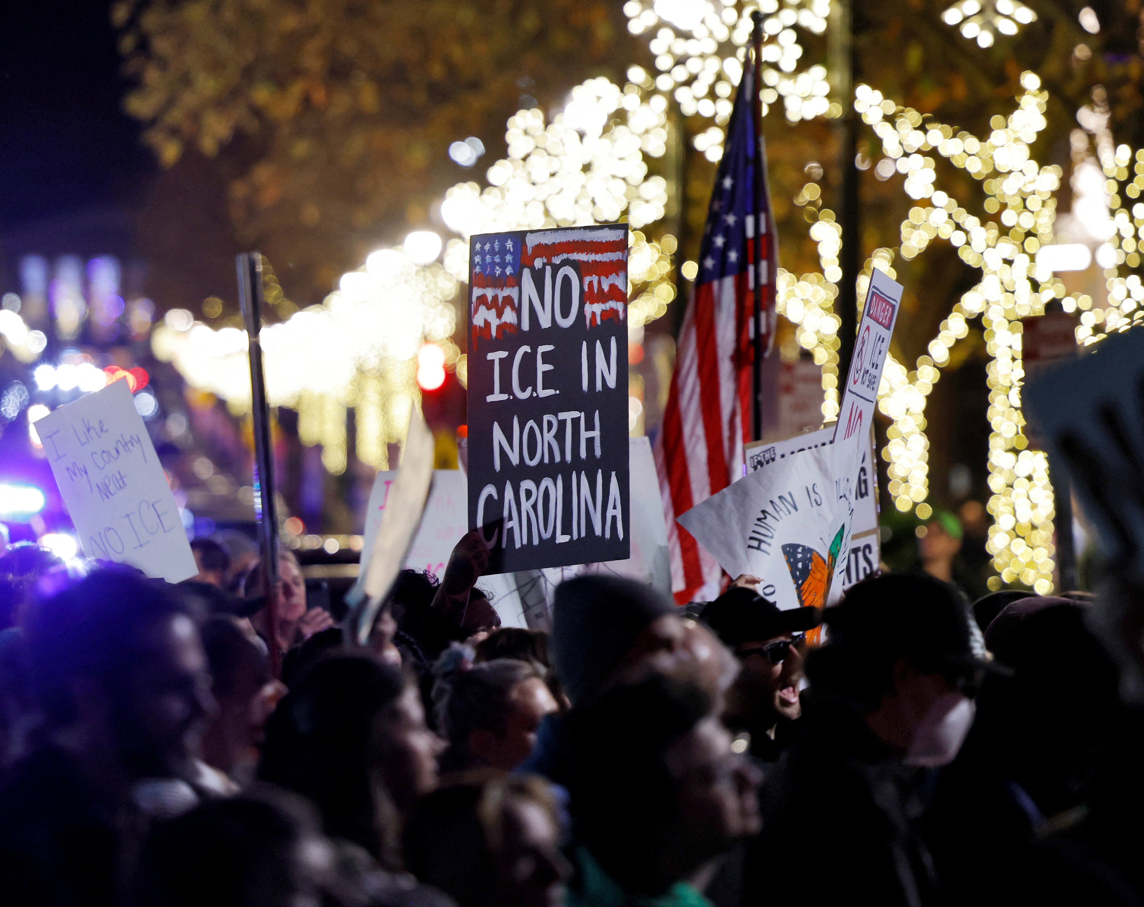 A protester in Raleigh holds up a sign that reads: ‘No ICE in North Carolina’