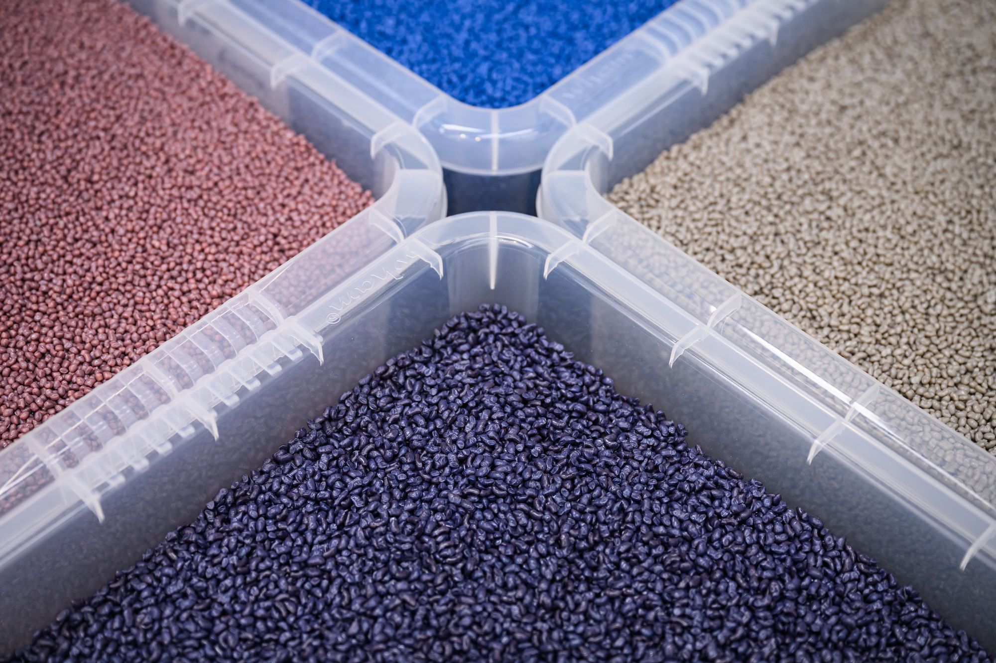 <p>Tubs of finished plastic pellets from differing production techniques</p>