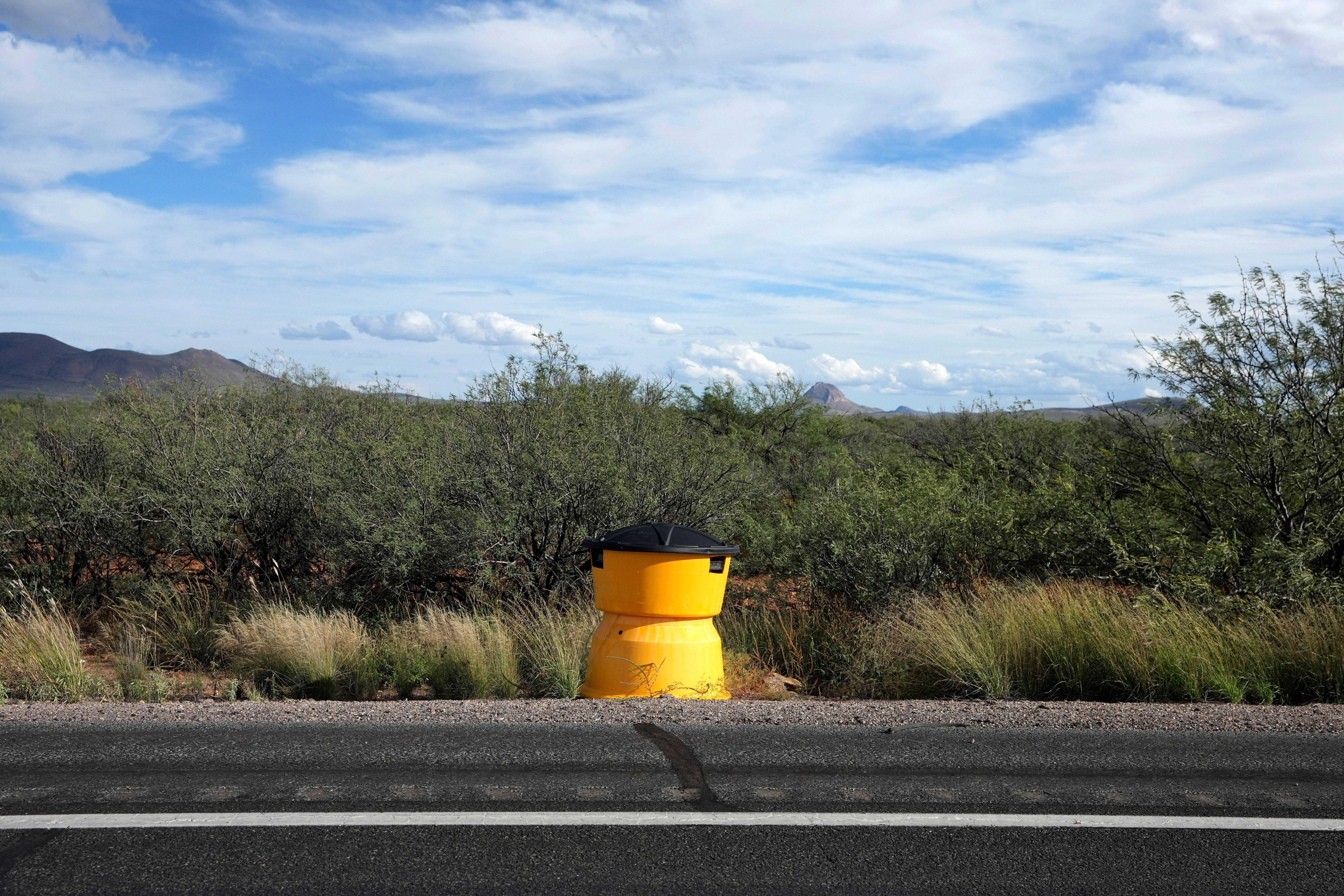 A license plate reader used by U.S. Border Patrol is hidden in a sand crash barrel along the state Highway 80, Thursday, Oct. 23, 2025, in Douglas, Ariz.