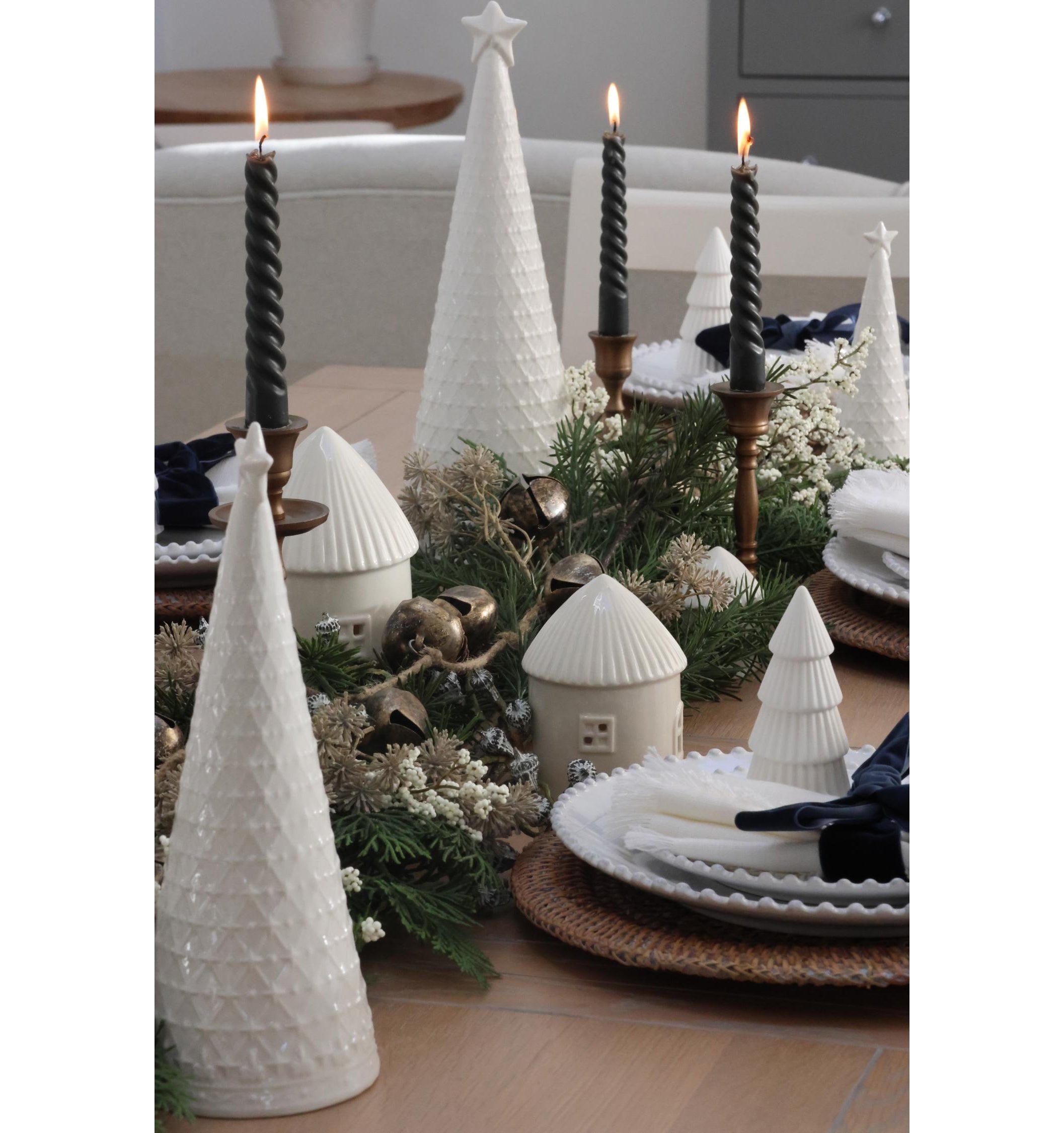 White Ceramic Christmas Trees – £12 each, (Large); White Ceramic Houses, from £6, (Small); Jingle Bell Garland, £22; rest of items from a selection, The Suffolk Nest