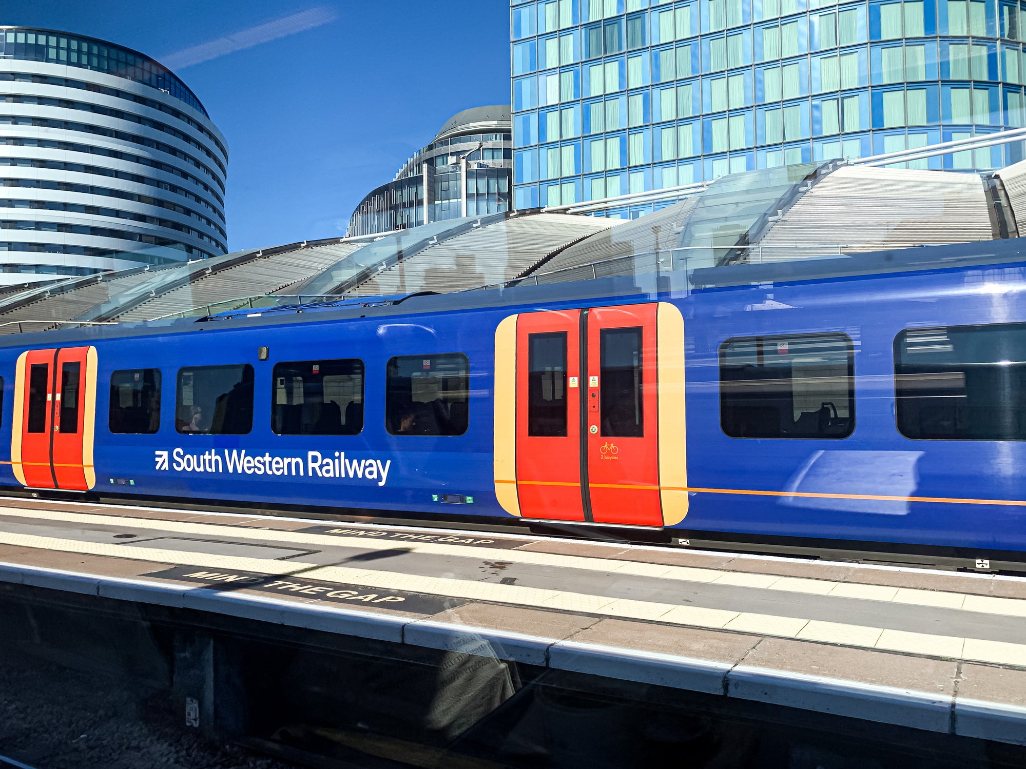 On most trains on South Western Railway, the guard opens and closes the doors.
