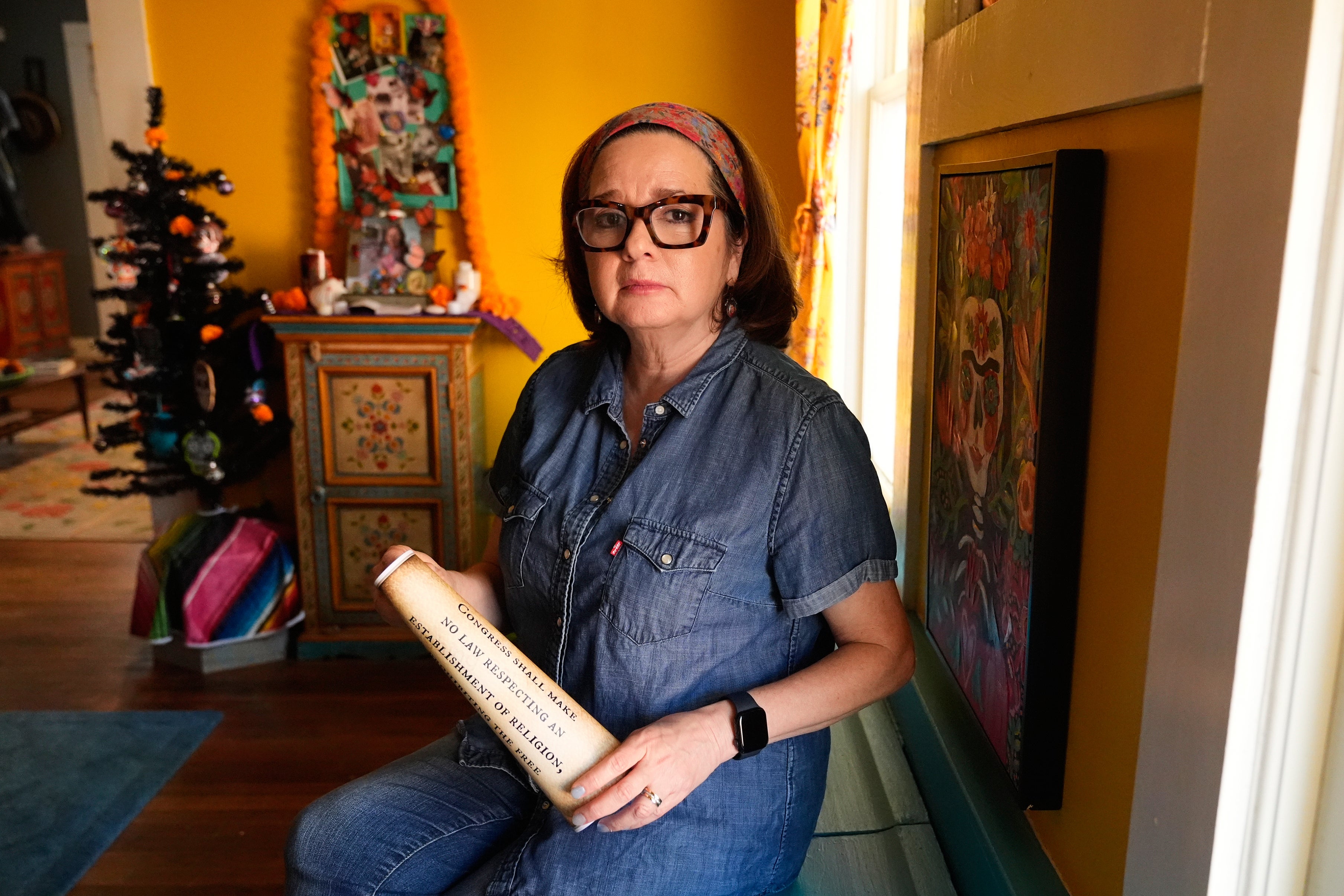 Gigi Cervantes, who resigned from her position as a theater teacher at a Fort Worth school rather than teach in a classroom where the Ten Commandments are hung, poses for a photo at her home, Wednesday, Nov. 5, 2025, in Fort Worth, Texas