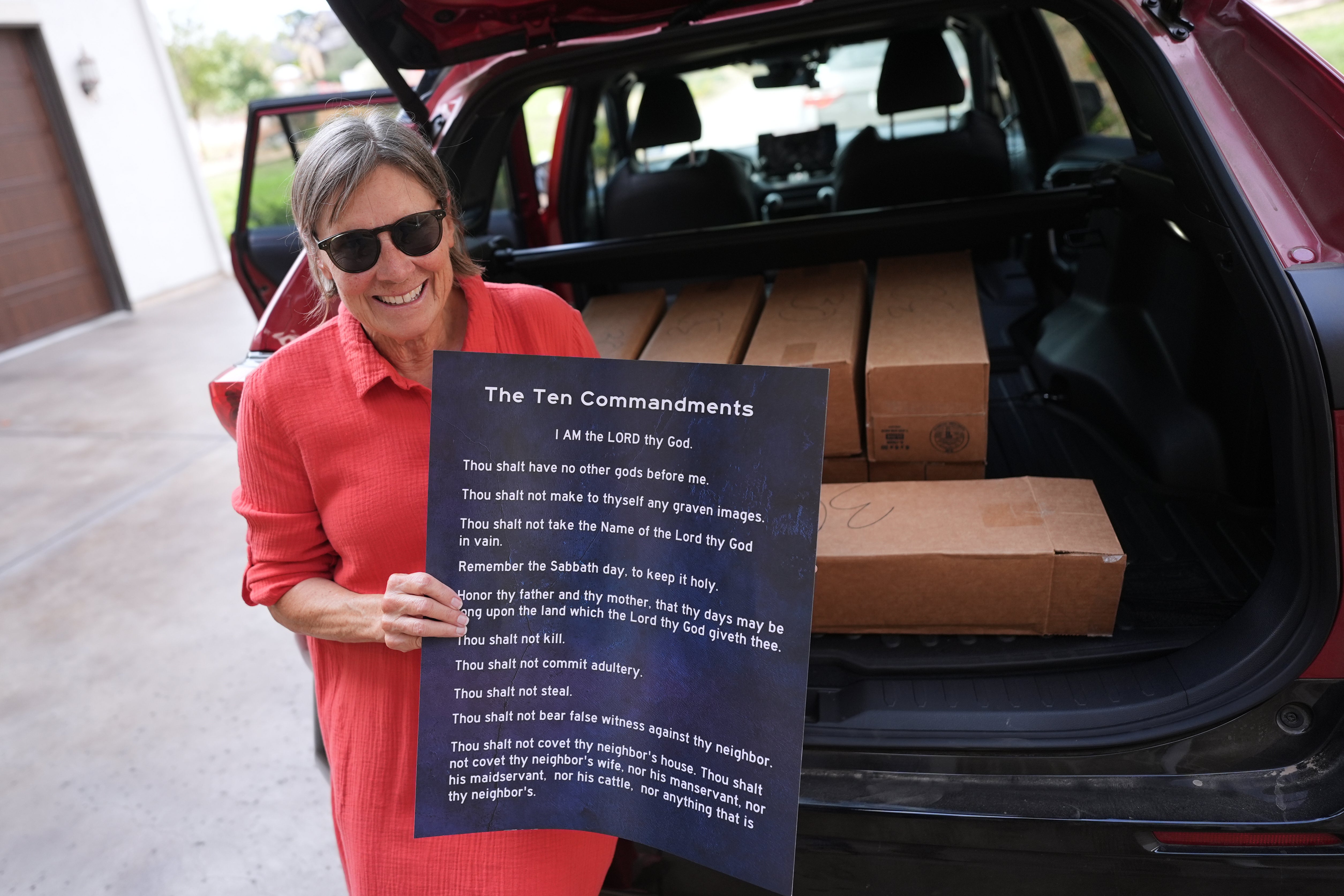 Debbie Leimback displays one of the hundreds of Ten Commandments posters she was preparing to deliver to local public schools in New Braunfels, Texas, Monday, Nov. 17, 2025