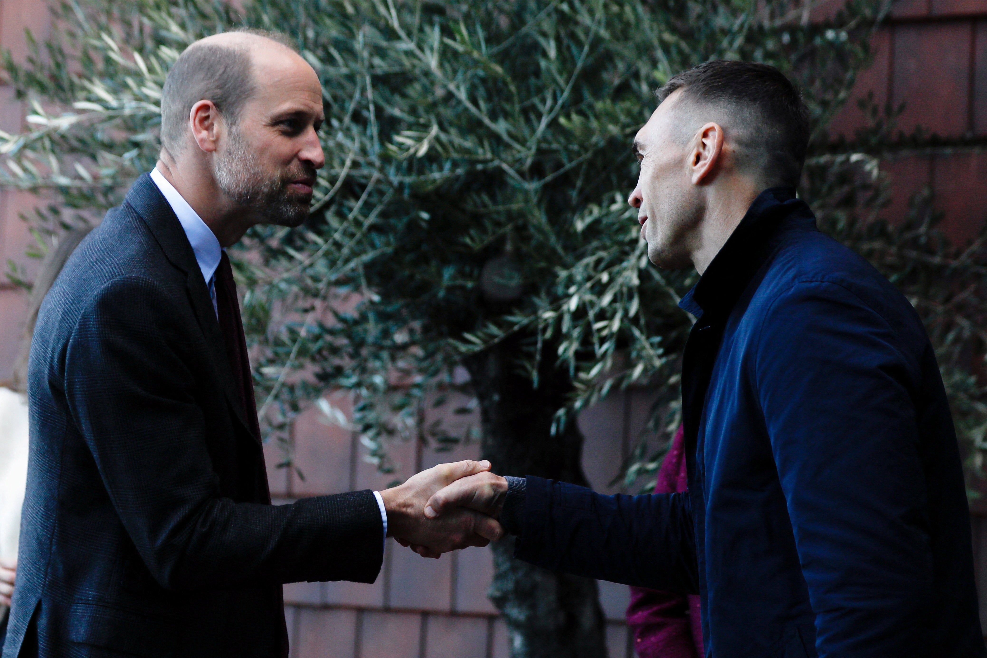 The Prince of Wales is welcomed by rugby union coach Kevin Sinfield, as he arrives to officially open the centre at Seacroft Hospital in Leeds