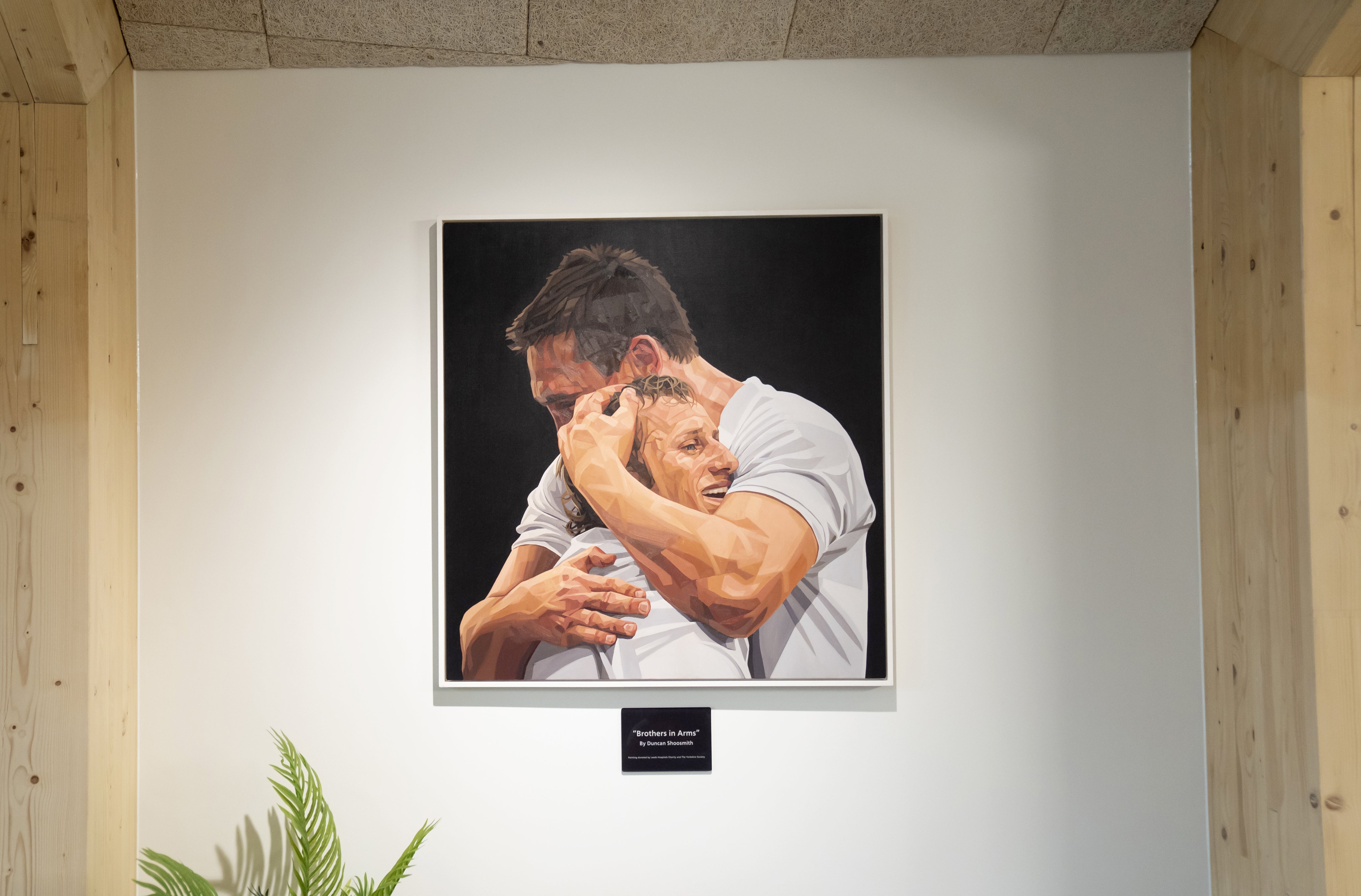 A painting of Rob Burrow being embraced by Kevin Sinfield at the opening of the centre