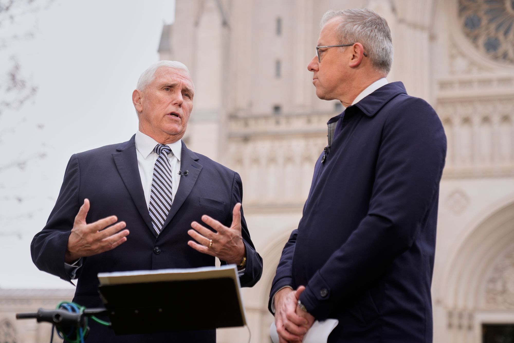 Former vice president Mike Pence speaks to CNN journalist Jeff Zeleny outside the church