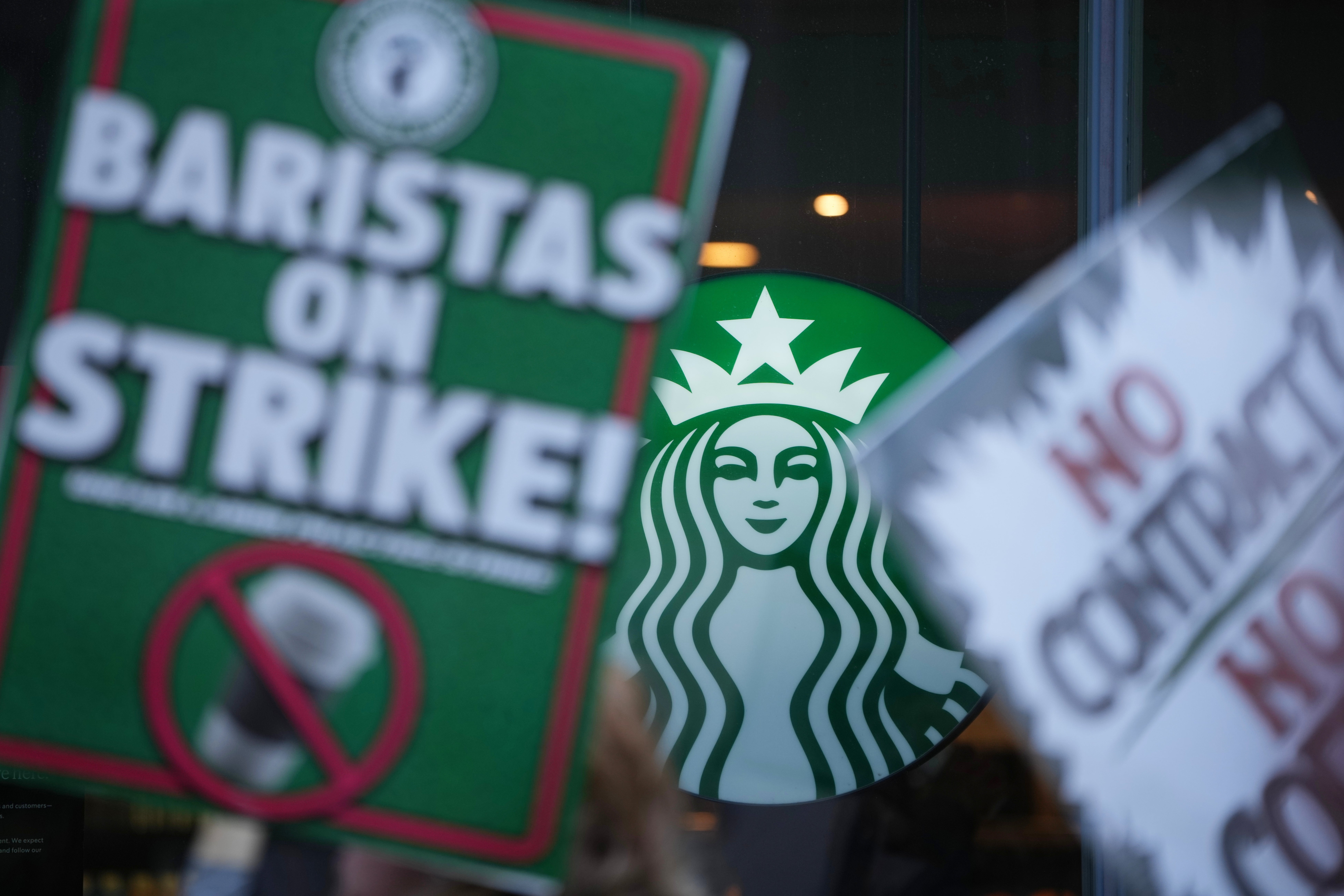 Protesters picket outside a Starbucks, Thursday, Nov. 13, 2025, in Philadelphia
