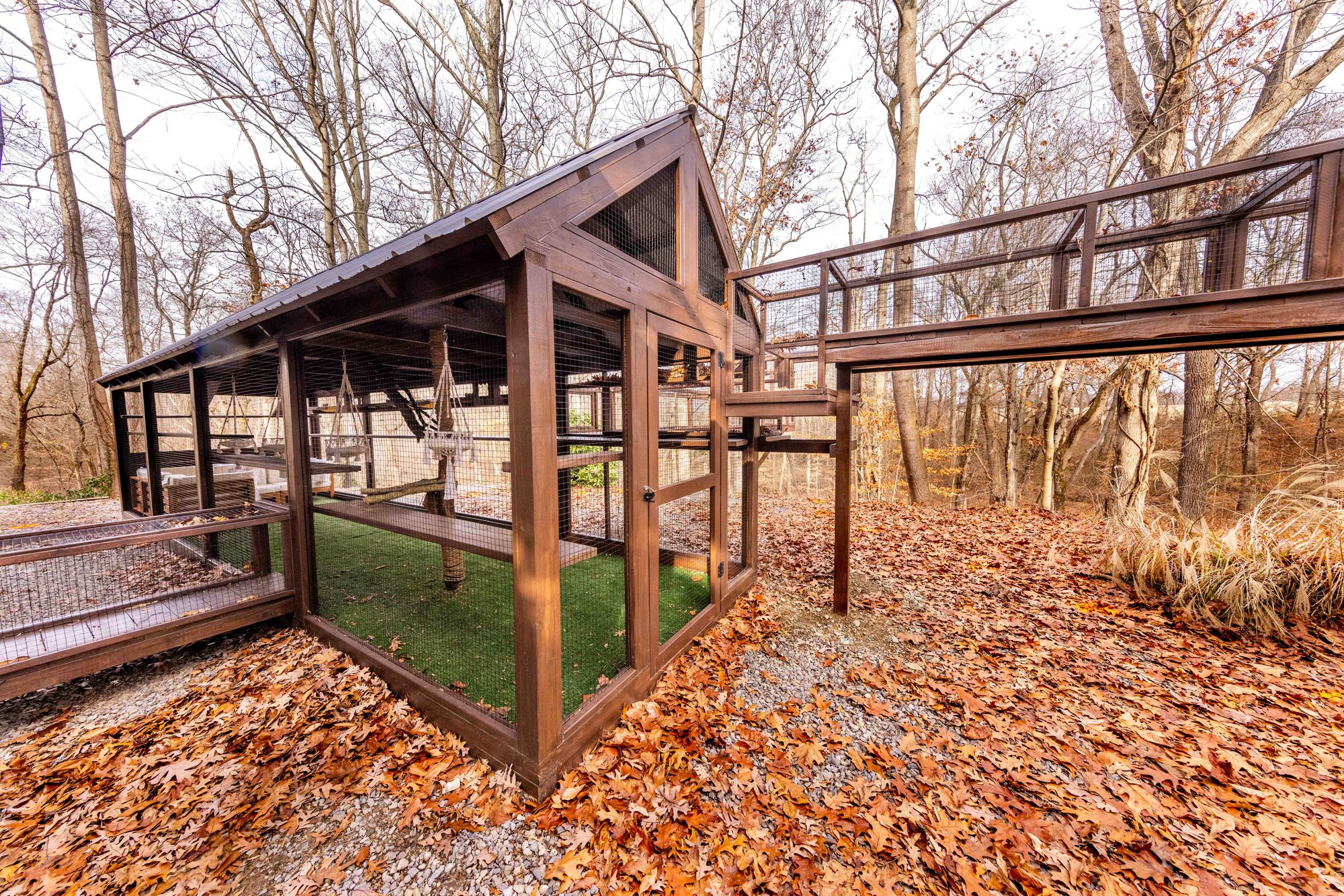 An outdoor wooden catio, with a roof, in Burlington County, New Jersey, that comes with scratching posts and running path for a cat
