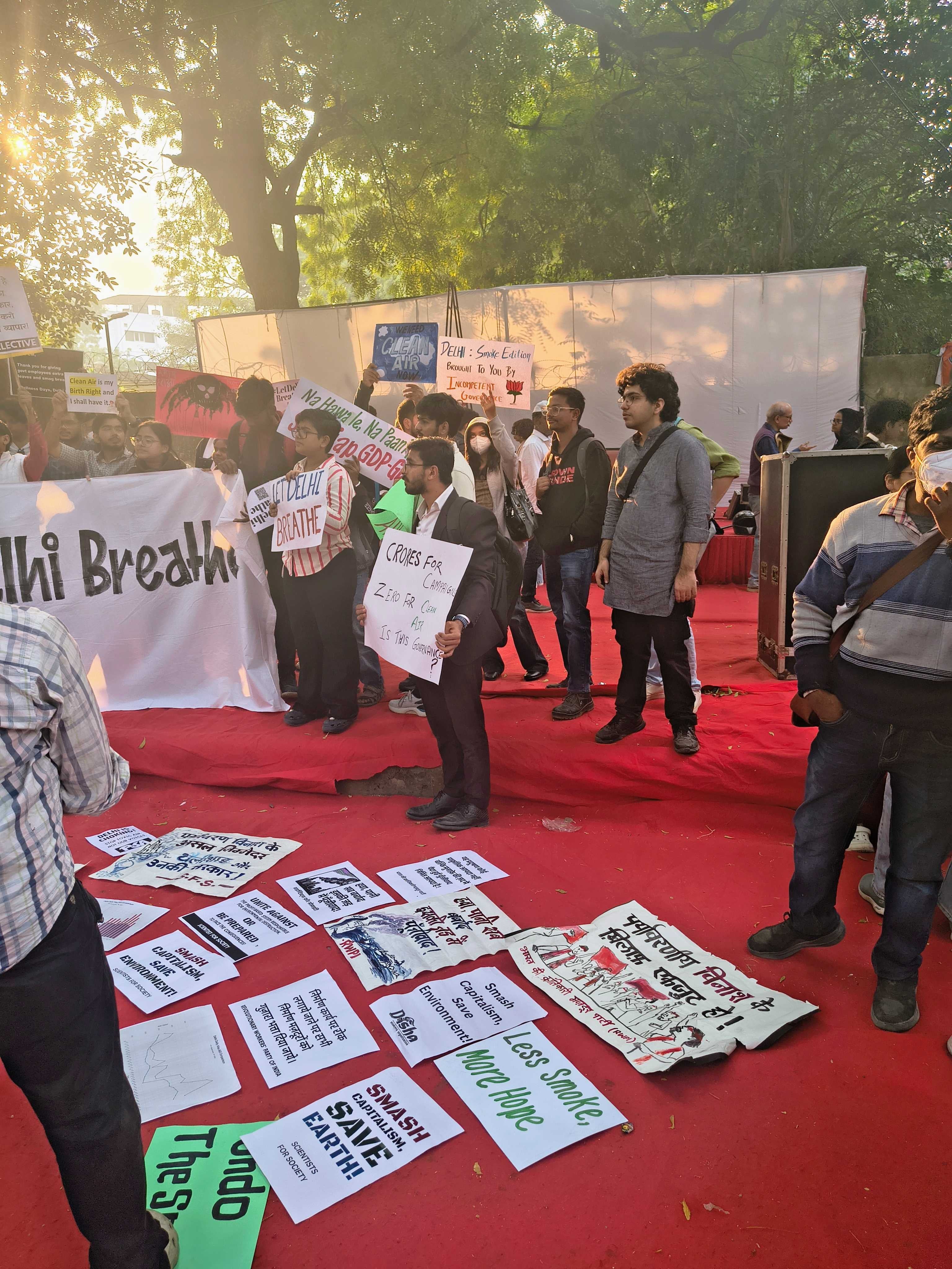 Protesters lay out placards on the ground calling for clean air and stronger government action to tackle pollution