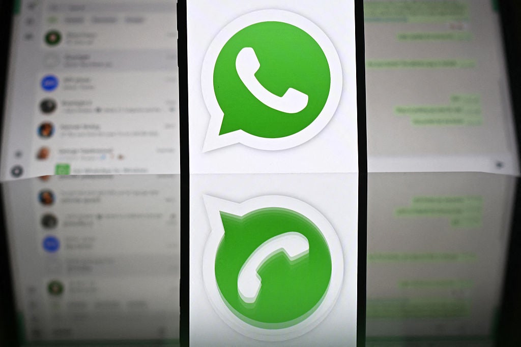 The WhatsApp logo pictured in front of a laptop screen in Guildford, UK, on 17 April, 2025