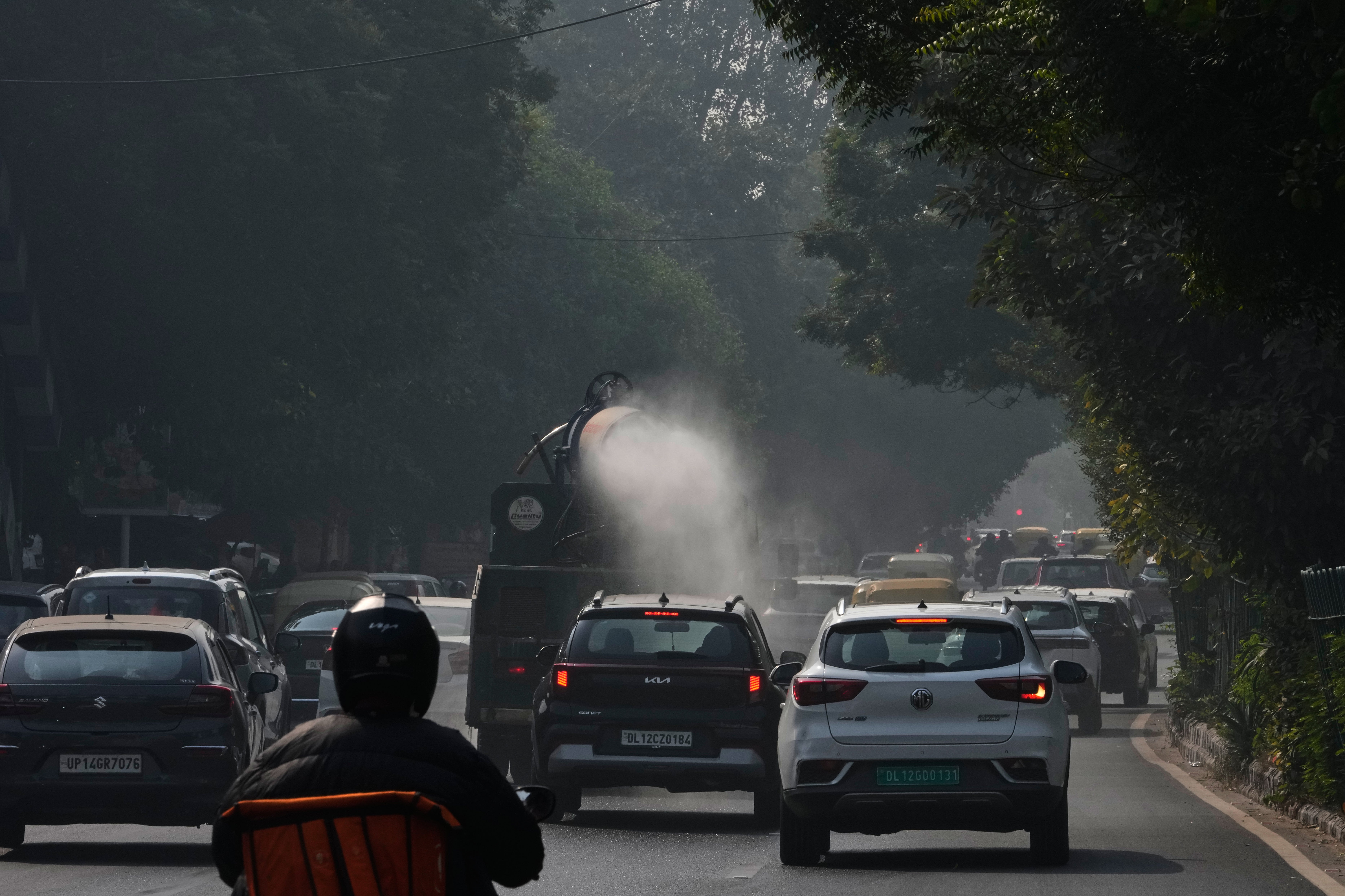 A government vehicle sprays water in an effort to control pollution in New Delhi, India, Tuesday, Nov. 18, 2025. (AP Photo/Manish Swarup)