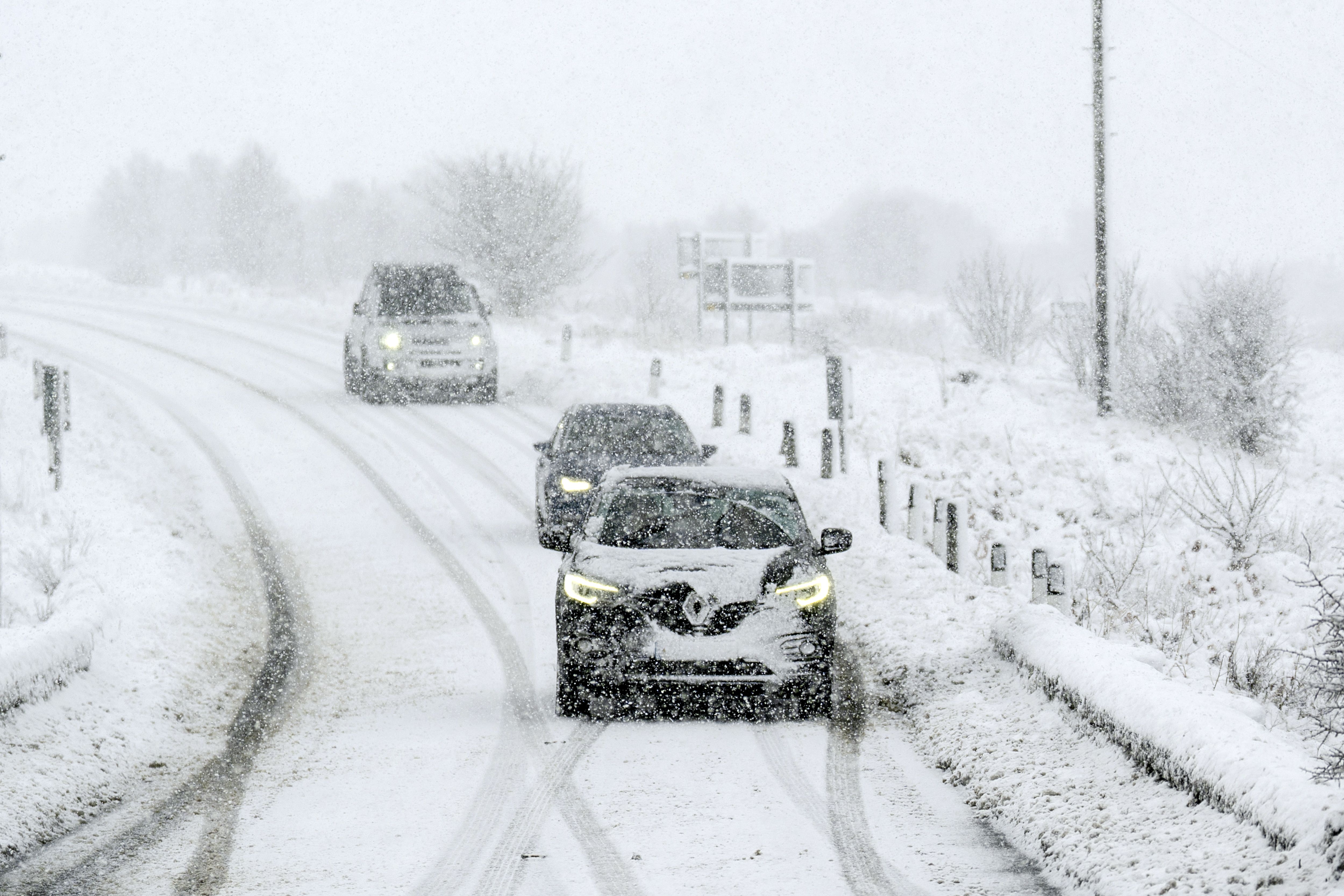 Cars driving through snow on the A169 between Pickering and Whitby on the North Yorkshire Moors (Danny Lawson/PA)