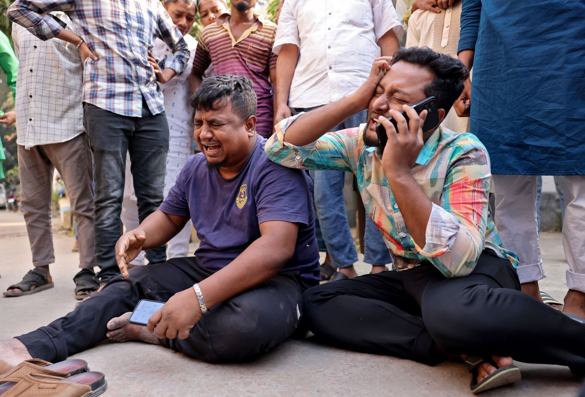 Men mourn the death of their relatives outside a hospital morgue following an earthquake in Dhaka, Bangladesh
