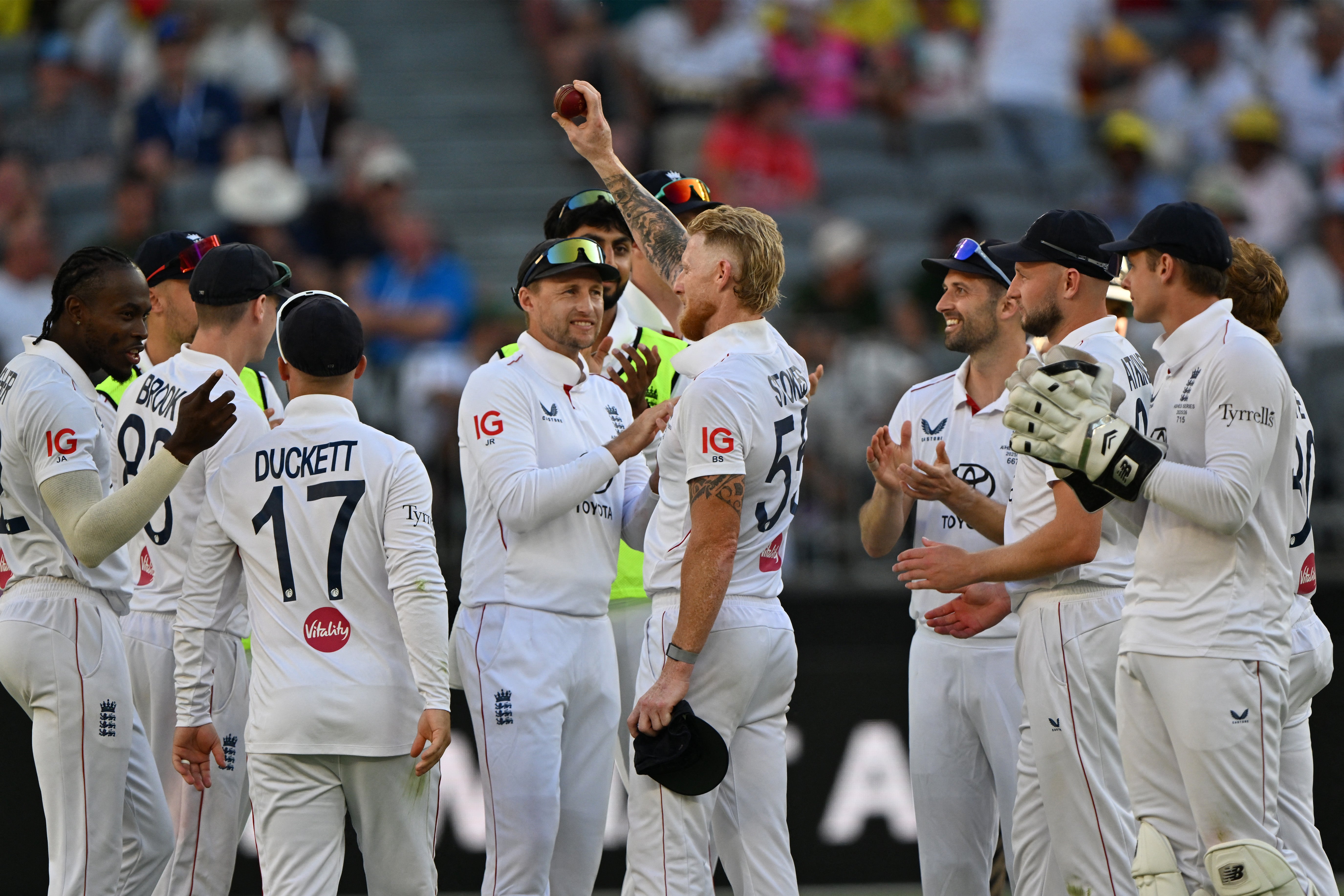 England’s Ben Stokes celebrates his five wickets with teammates on day one