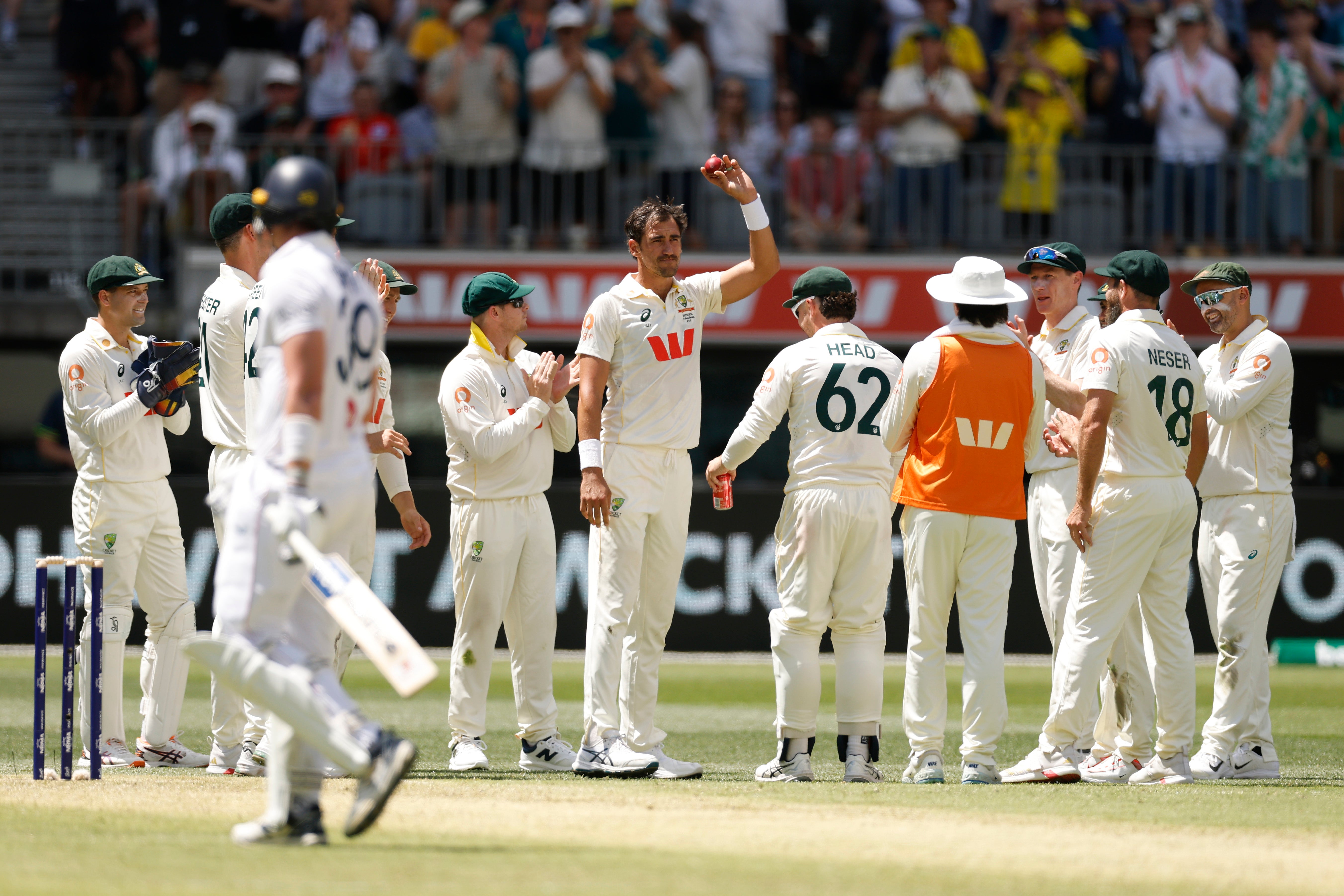Starc of Australia holds the ball aloft after taking his fifth wicket