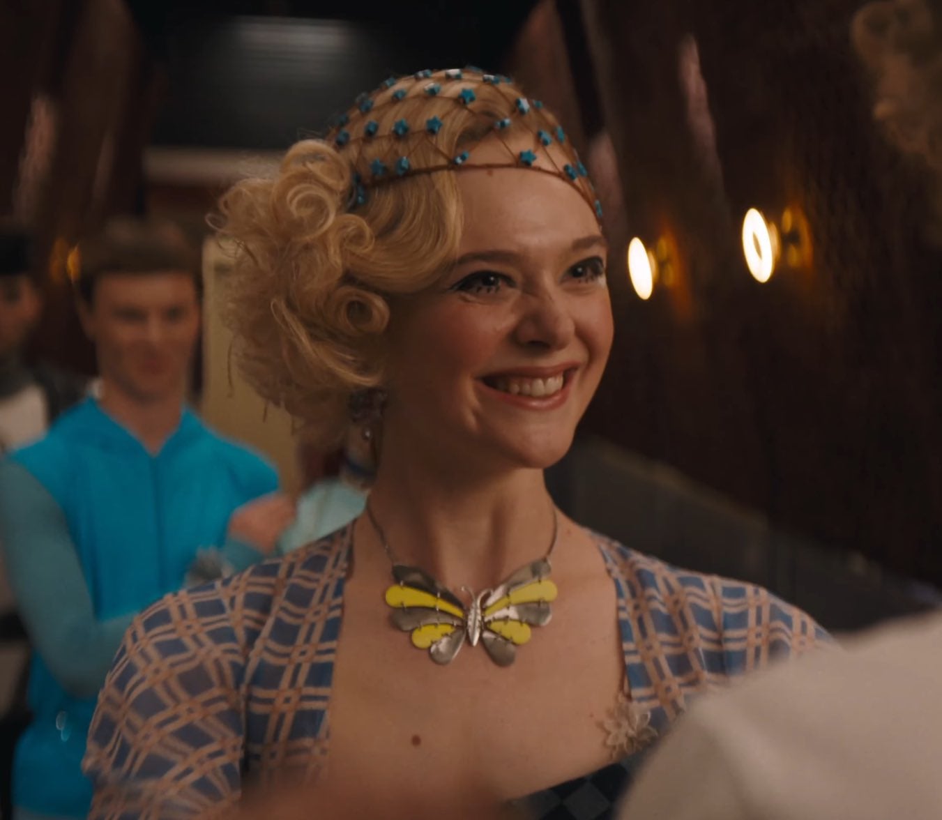 There’s a quick glimpse of Elle Fanning as young Effie Trinket, originally played by Elizabeth Banks