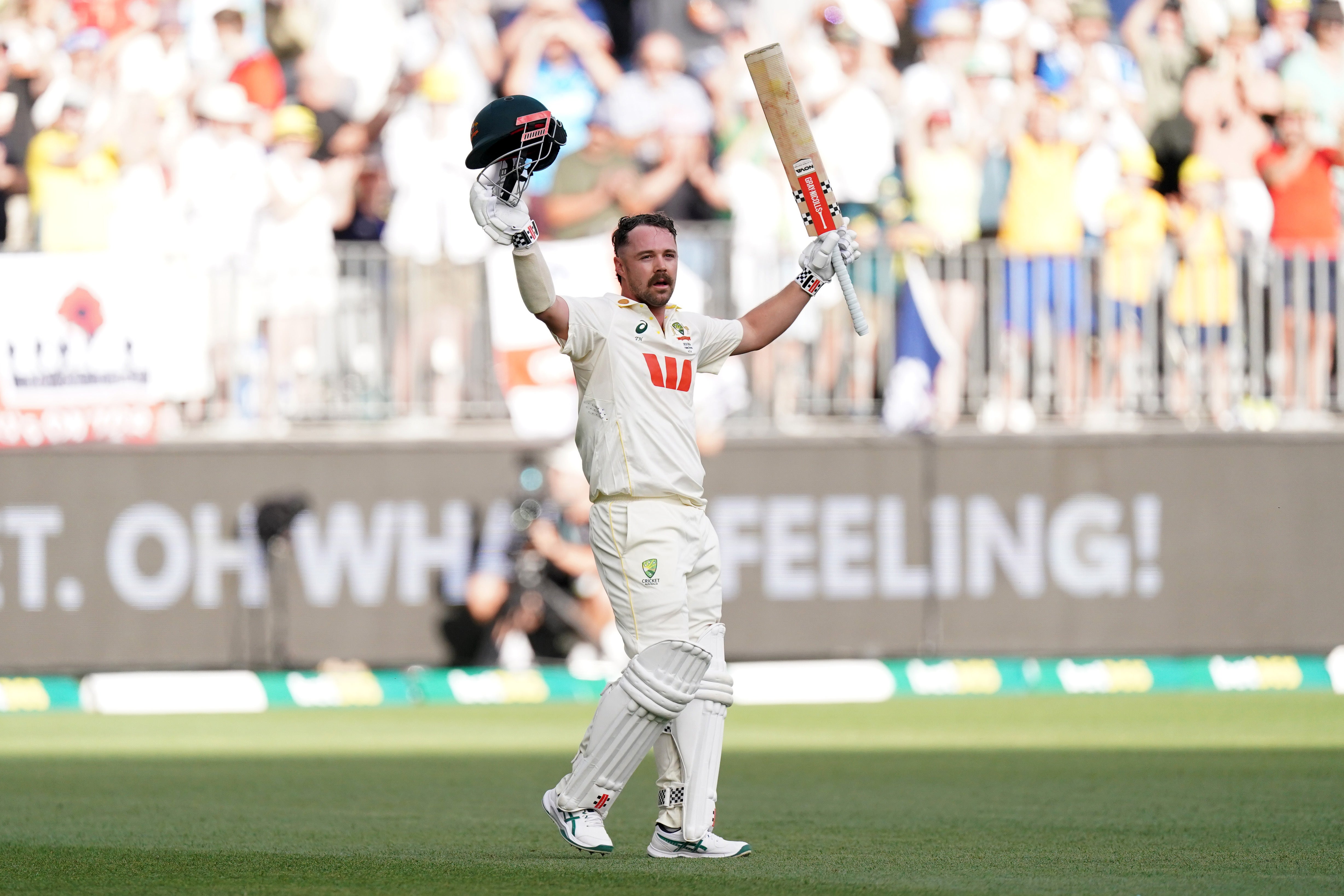 Travis Head raises his bat as he walks off the field after being dismissed (Robbie Stephenson/PA)