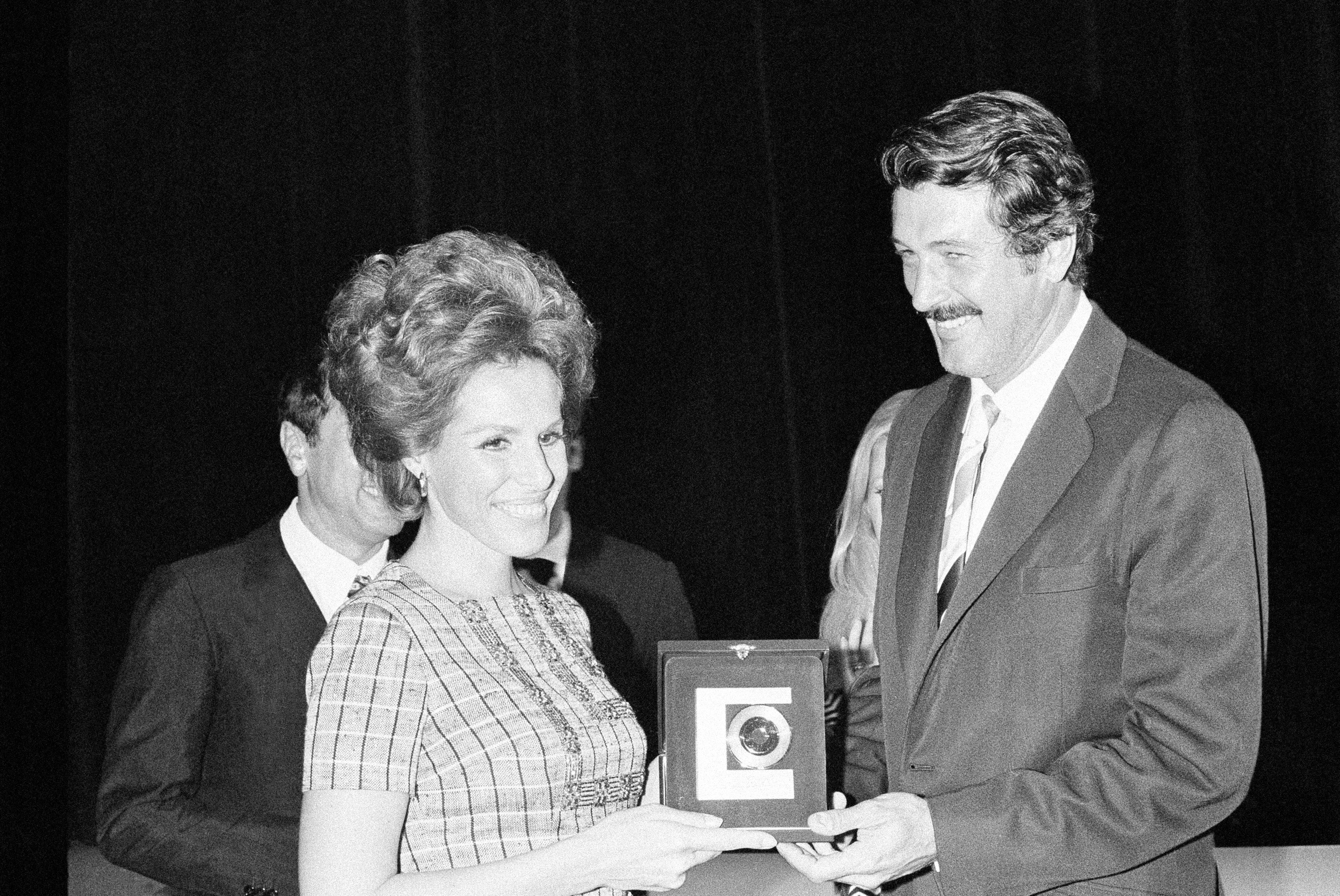 American actor Rock Hudson hands the "Golden Record" to Italian singer Ornella Vanoni, at a ceremony in the Piccolo Teatro