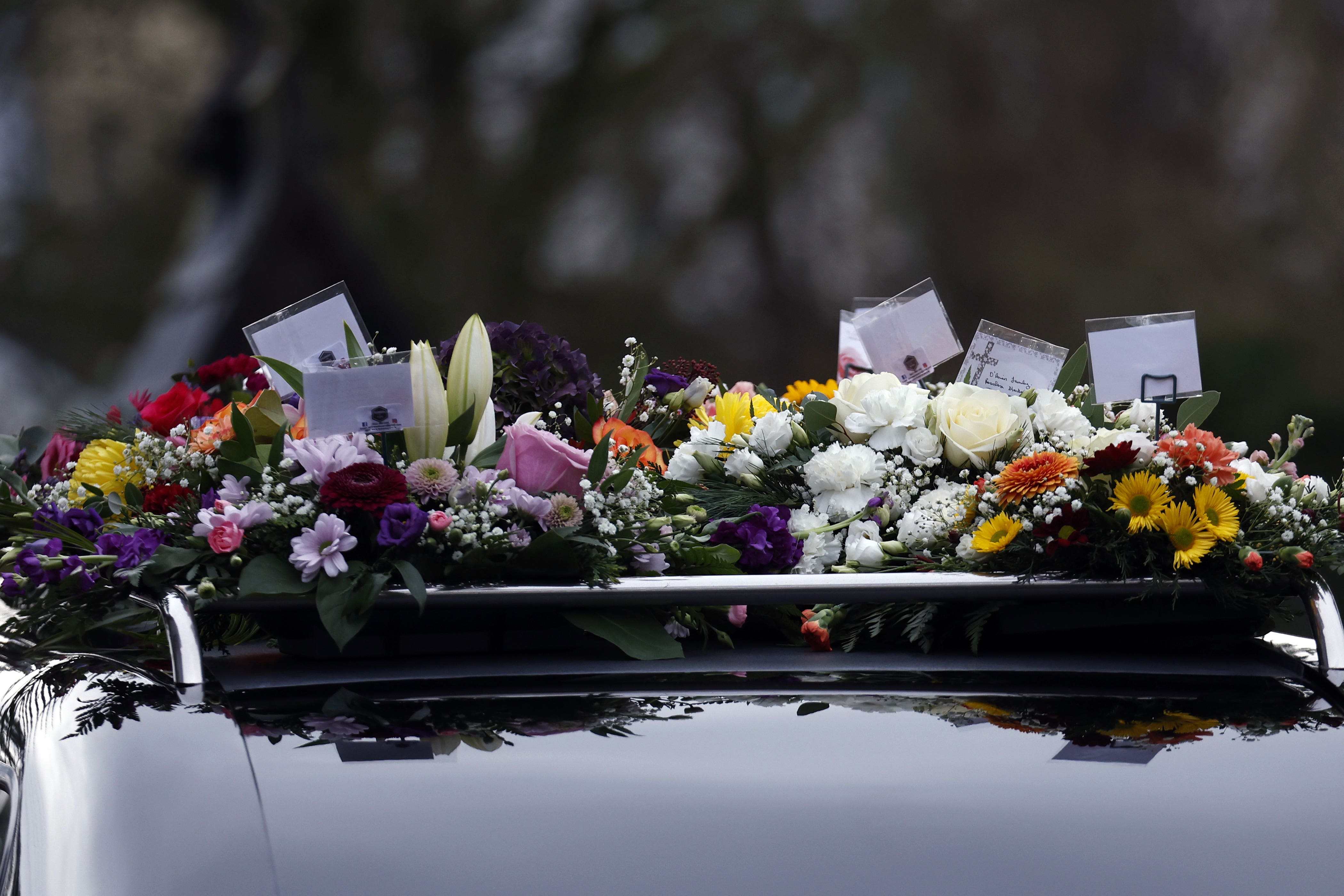 Tribute wreaths sit atop the hearse at Chloe McGee’s funeral (Conor O Mearain/PA)