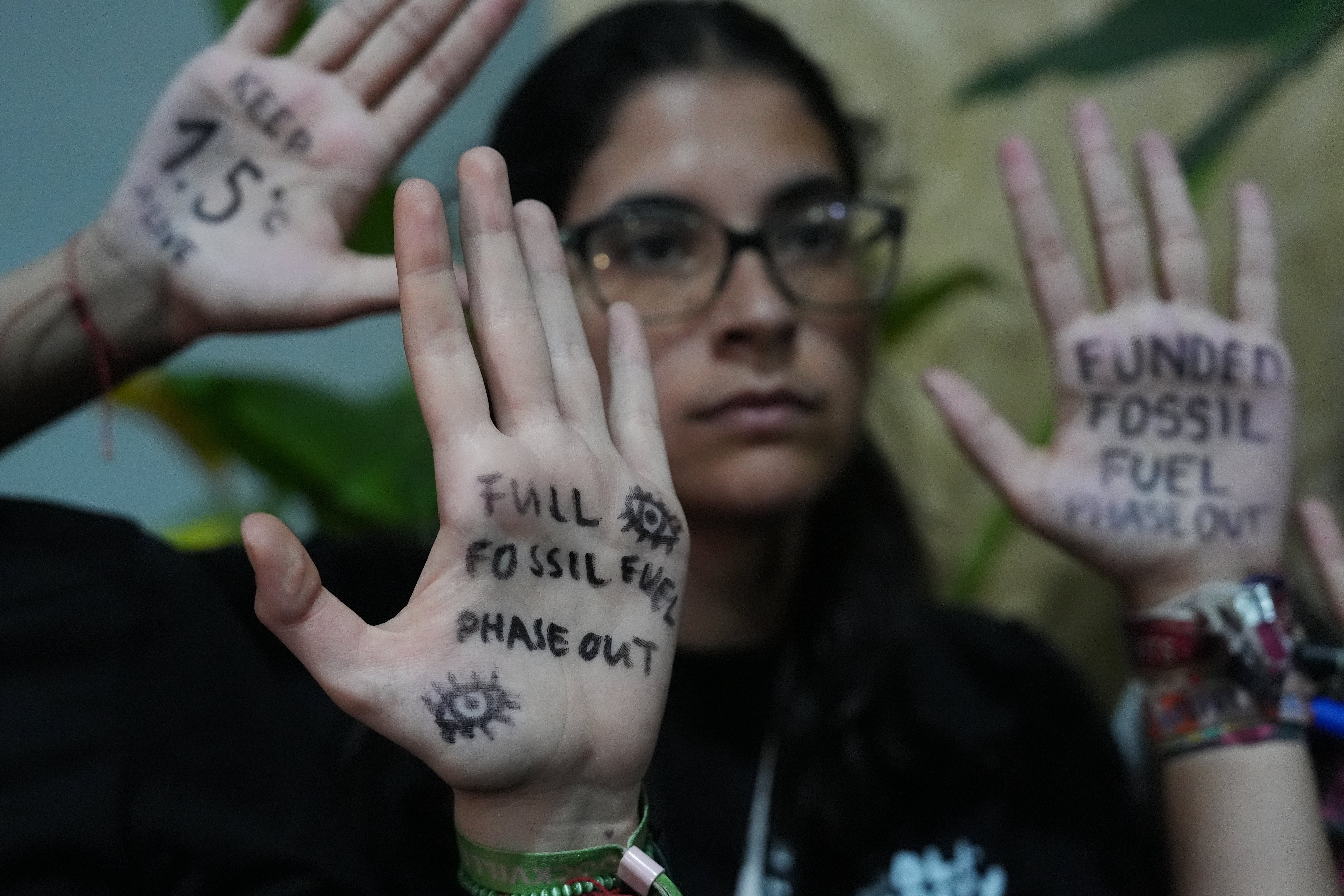 Activists participate in a demonstration outside where negotiations are taking place at the COP30 U.N. Climate Summit, Friday, Nov. 21, 2025, in Belem, Brazil. (AP Photo/Joshua A. Bickel)