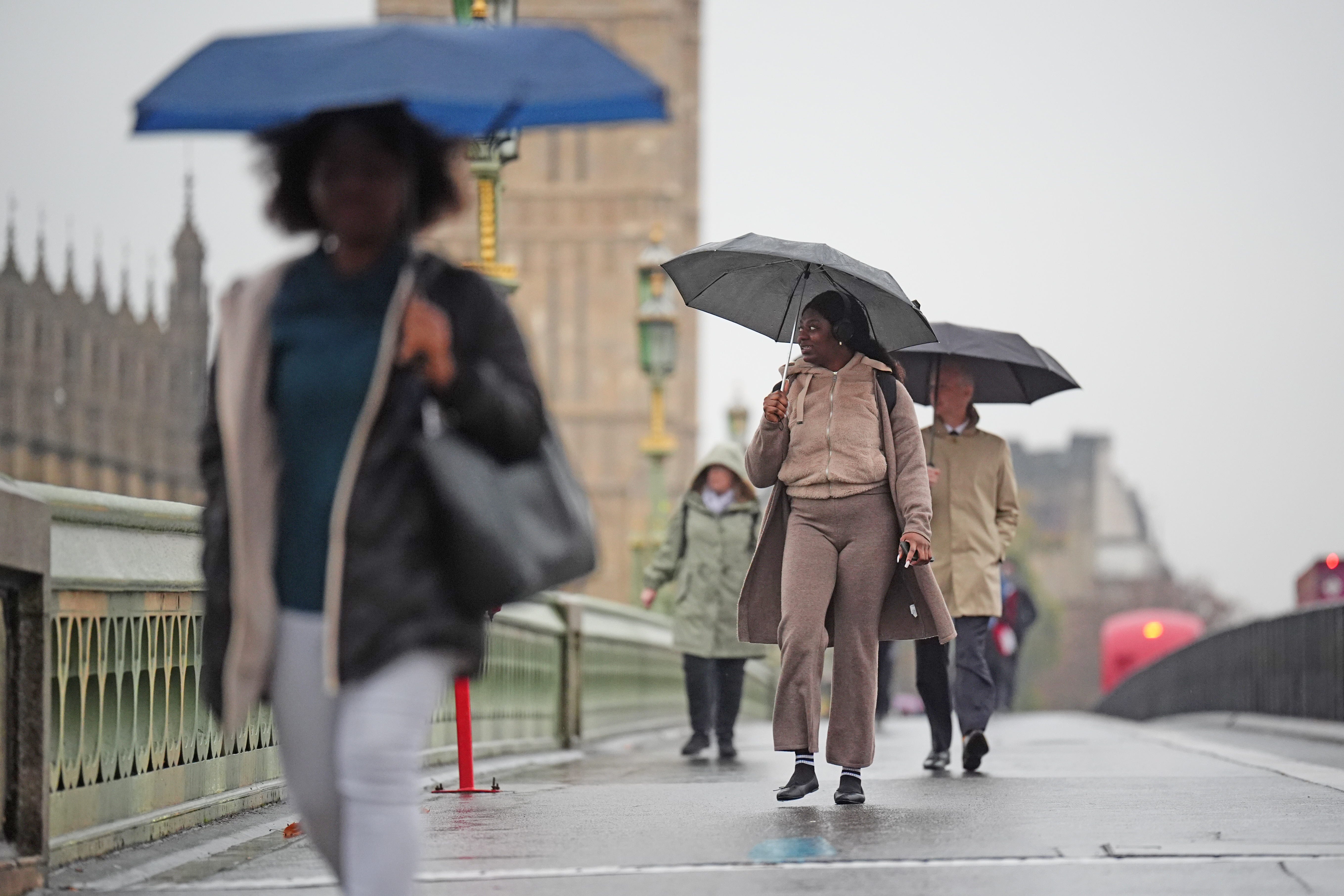 A stock picture of people walking in the rain across Westminster Bridge in central London. (James Manning/PA)