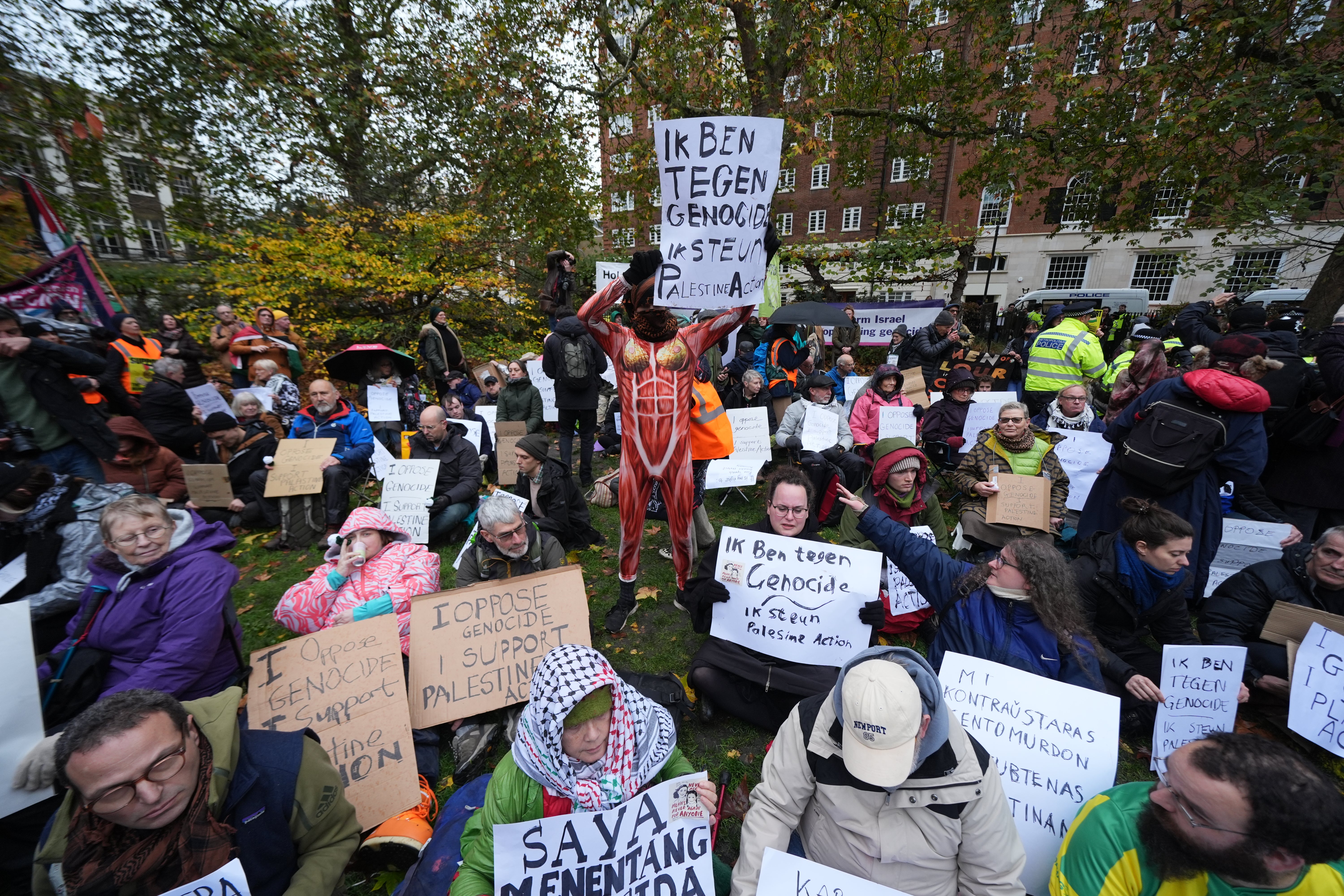 Campaigners at the Defend Our Juries protest in support of Palestine Action at The Peace Garden, Tavistock Square, central London
