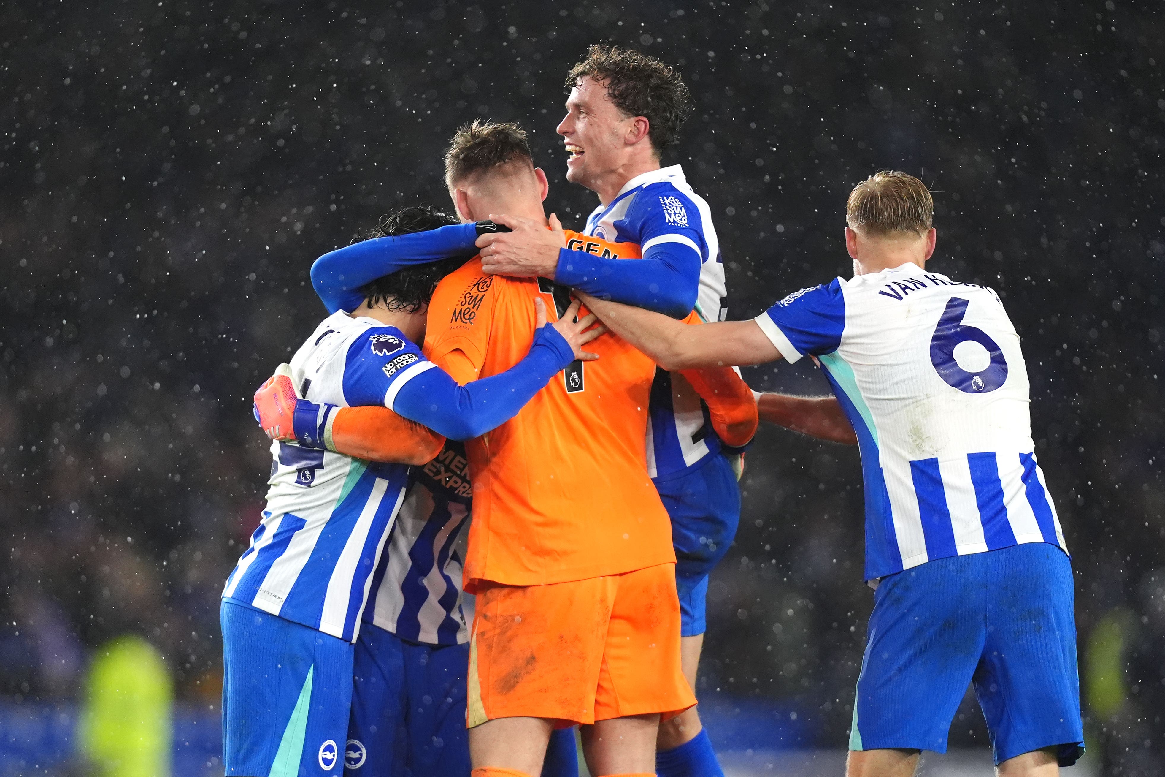 Brighton players celebrate with goalkeeper Bart Verbruggen after his stoppage-time heroics against Brentford (John Walton/PA)