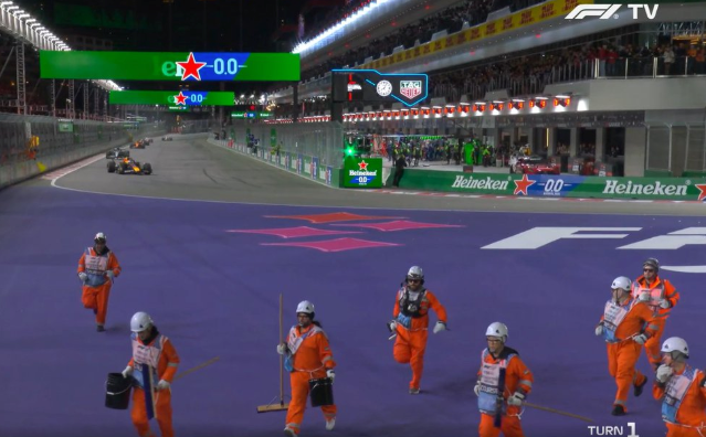 Marshals run off track at the start of the Las Vegas GP with Max Verstappen storming round