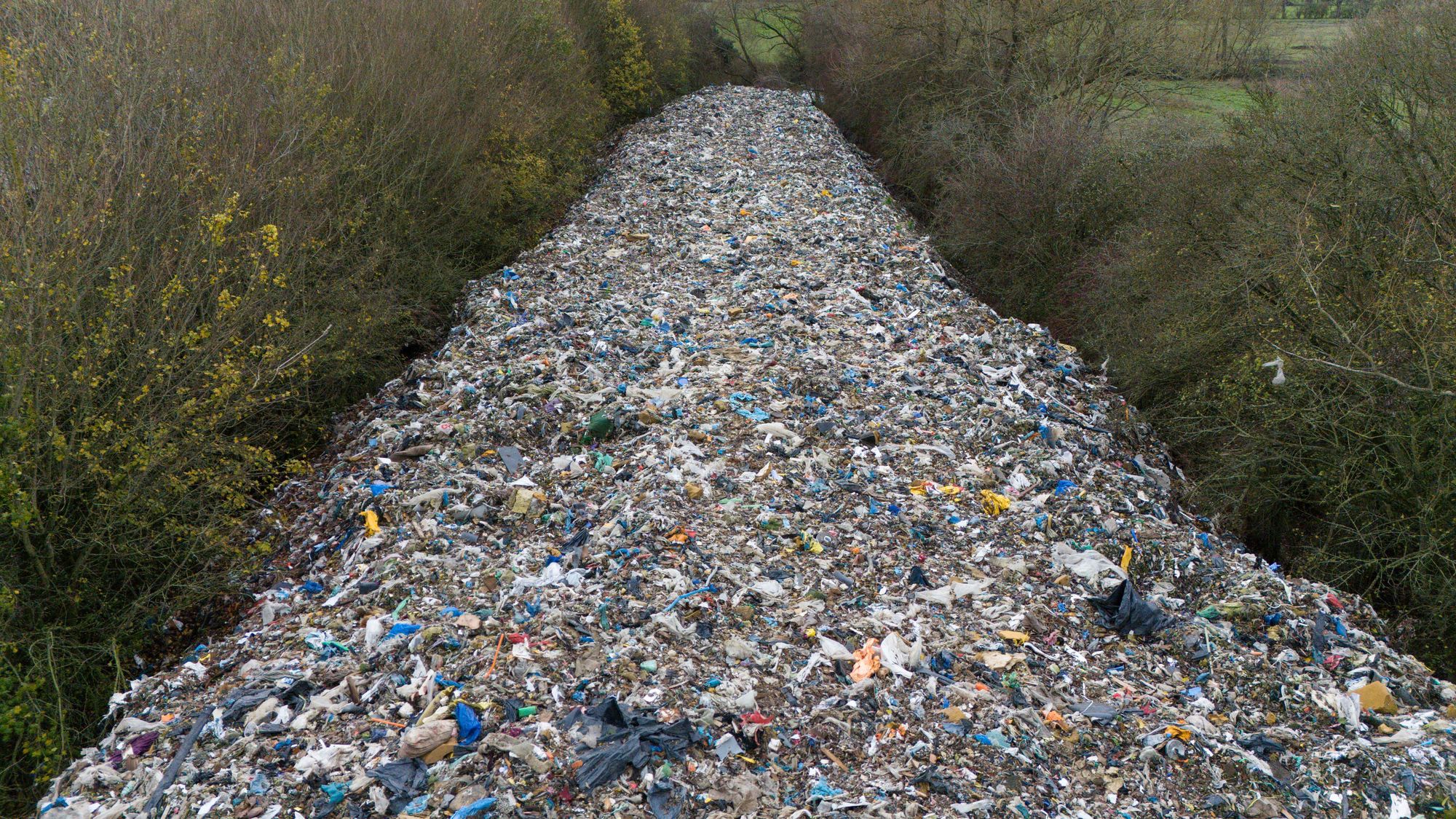 The illegal fly-tipping site near the River Cherwell has sparked major outrage among residents and MPs