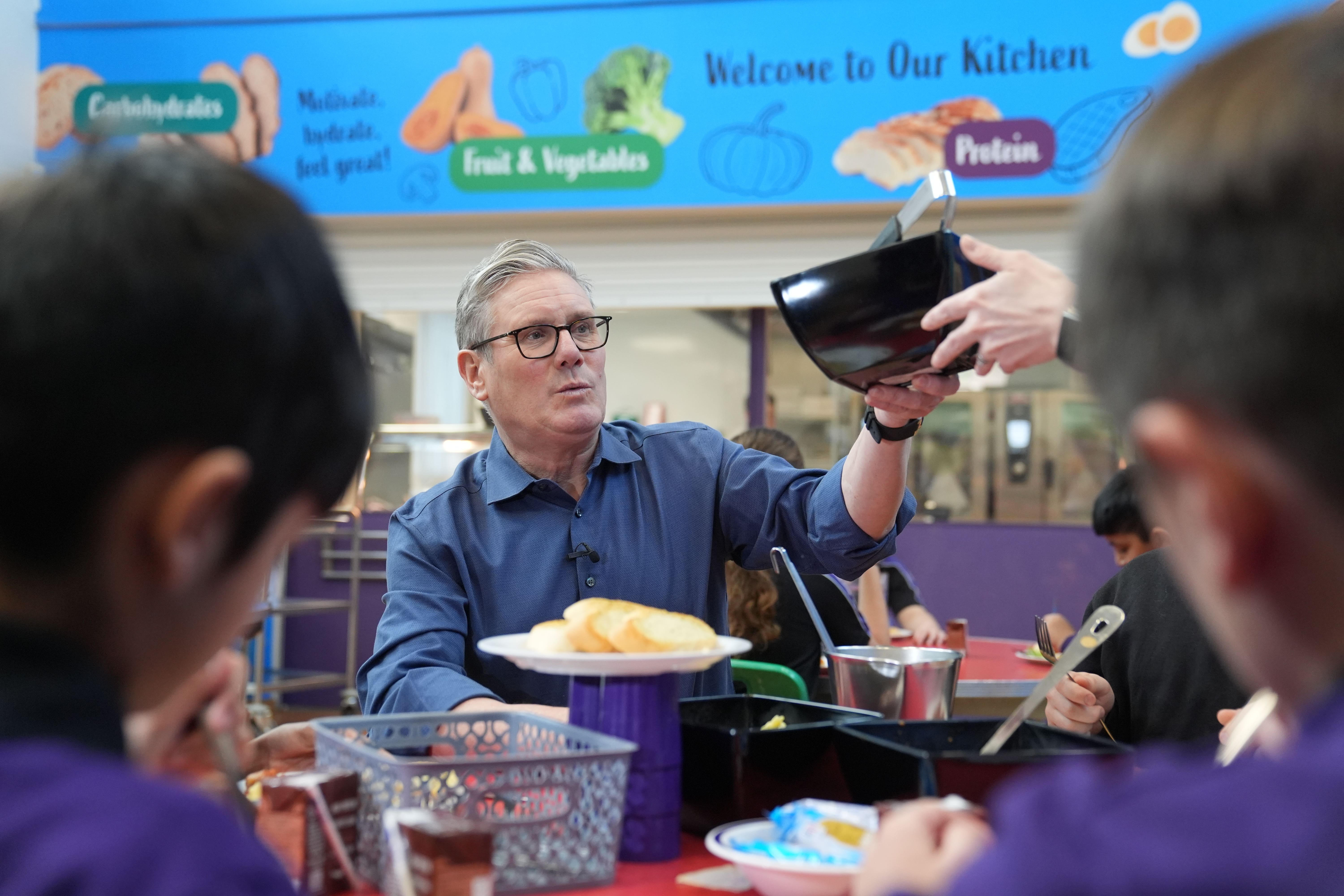 Prime Minister Sir Keir Starmer helping to serve lunch (Joe Giddens/ PA)