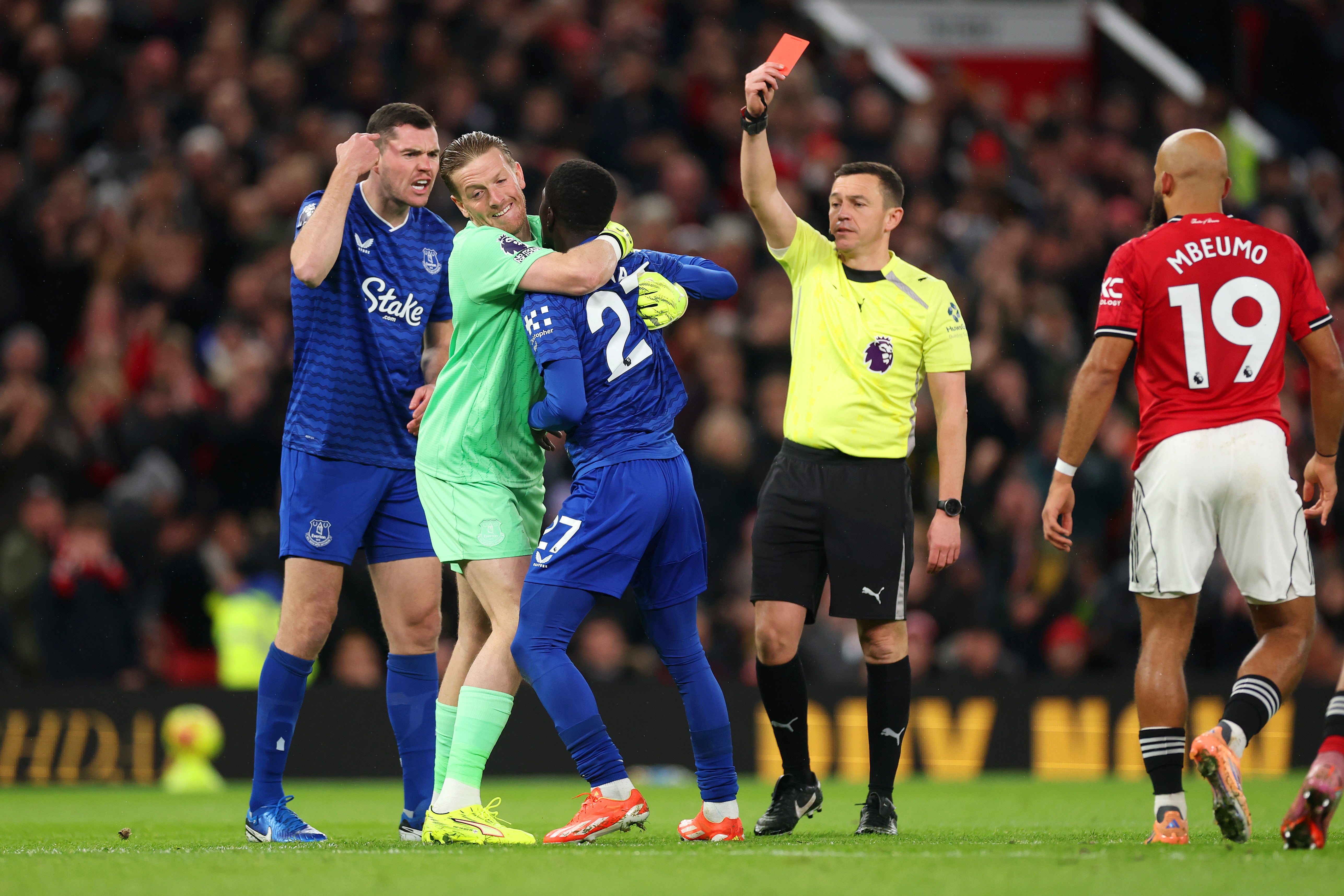 Everton's Idrissa Gueye is held back by Jordan Pickford after a confrontation with team-mate Michael Keane