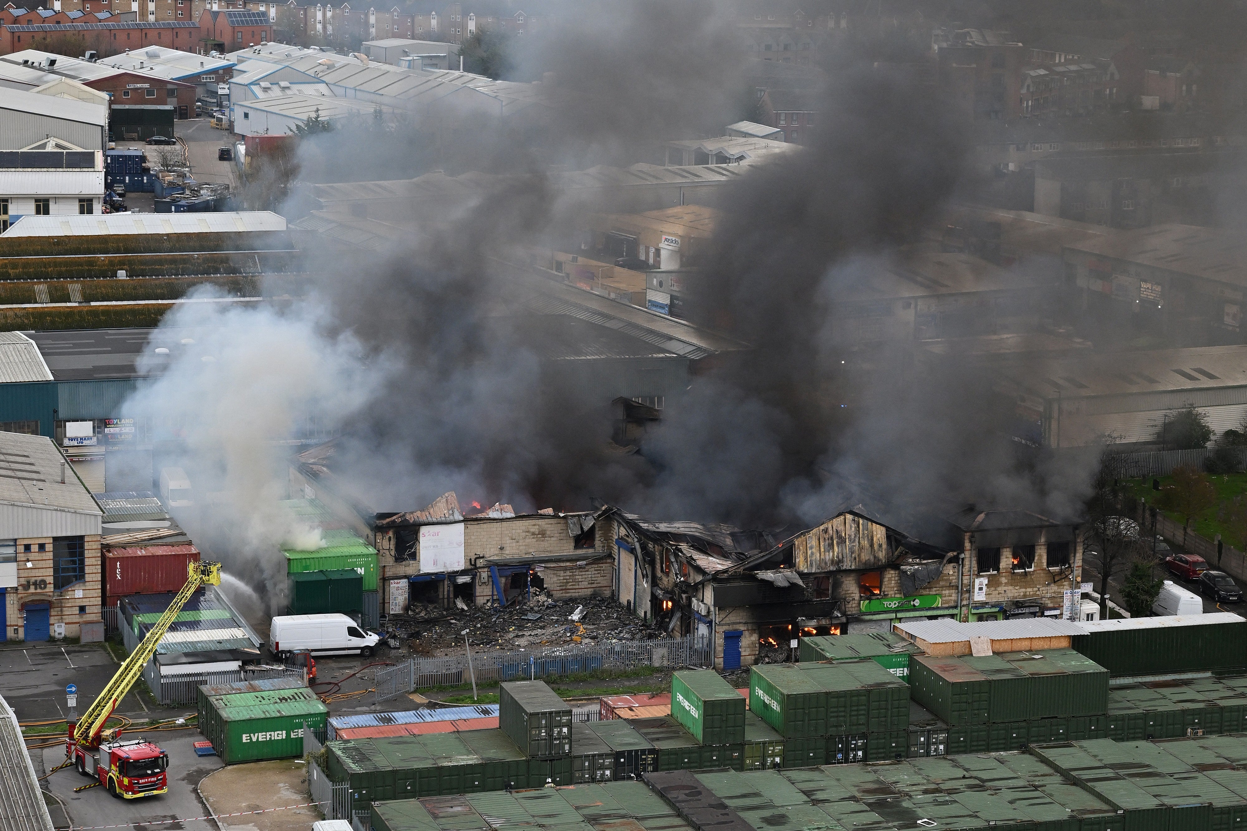 Thick smoke rising into the air as over 100 firefighters battle a large blaze in the Southall area of London
