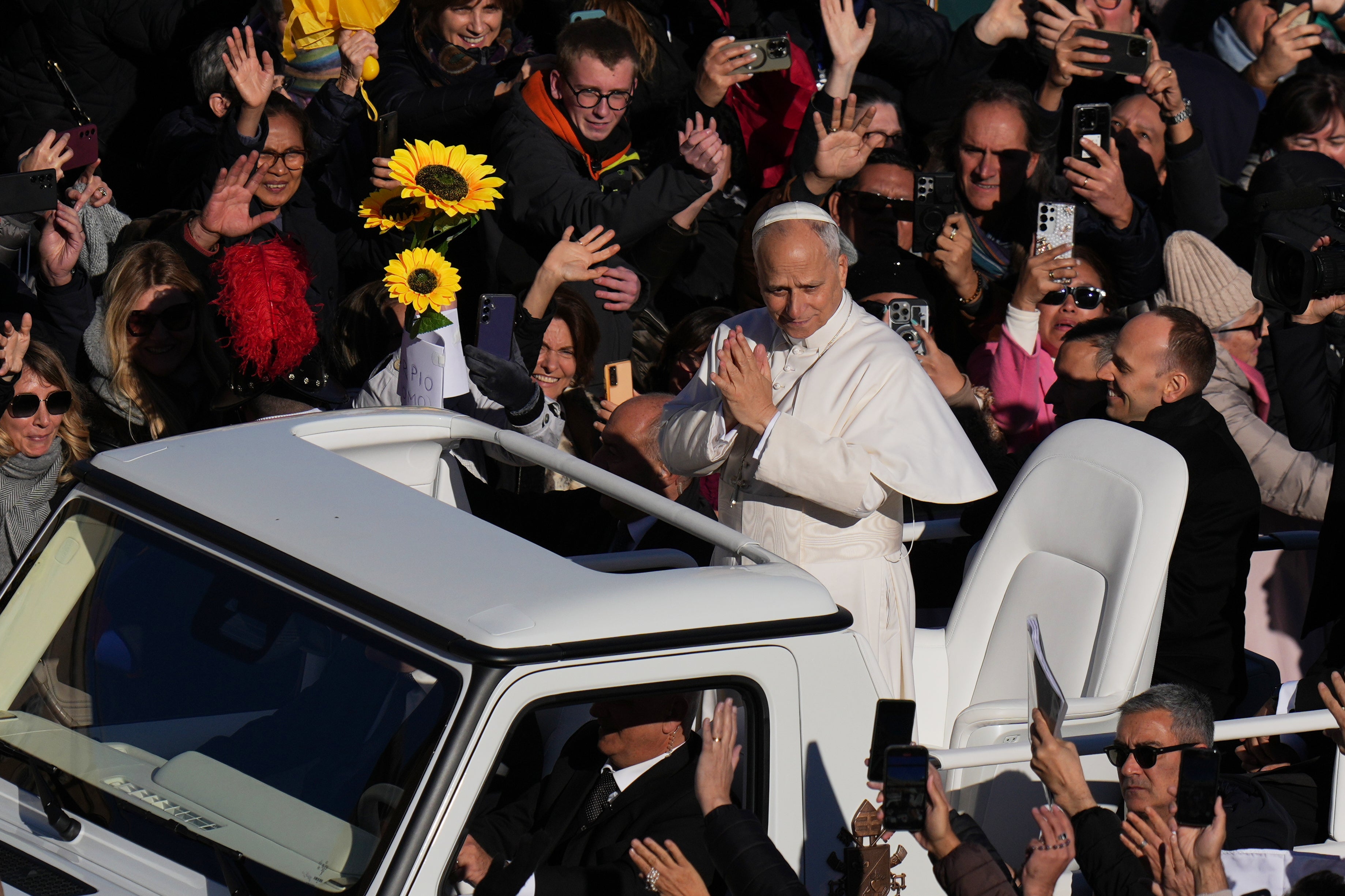 Pope Leo XIV waves as he leaves after celebrating a Mass for the Jubilee of the Choirs in St. Peter's Square, at the Vatican, Sunday, Nov. 23, 2025
