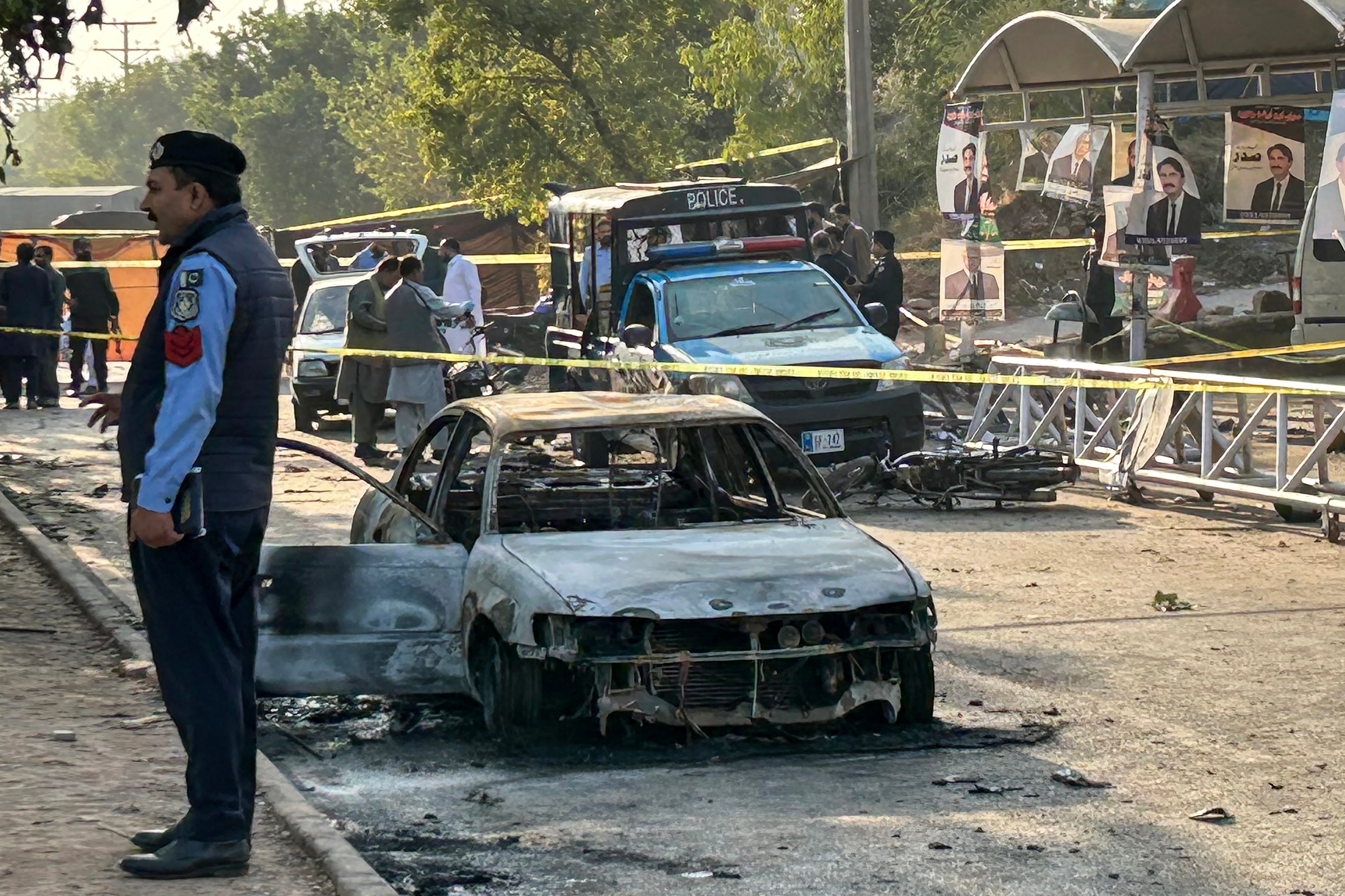 File. Policemen assess damaged vehicles after a suicide bombing outside a court in Islamabad on 11 November 2025