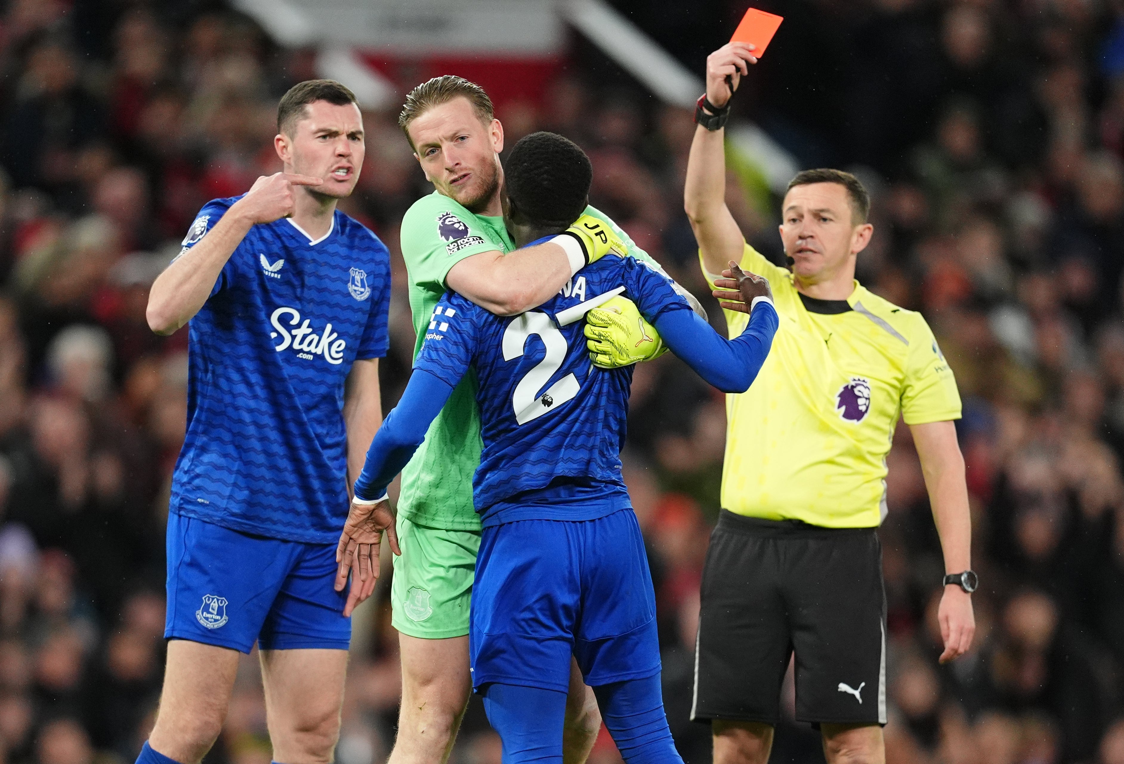Everton's Idrissa Gueye is held back by Jordan Pickford after a confrontation with team-mate Michael Keane