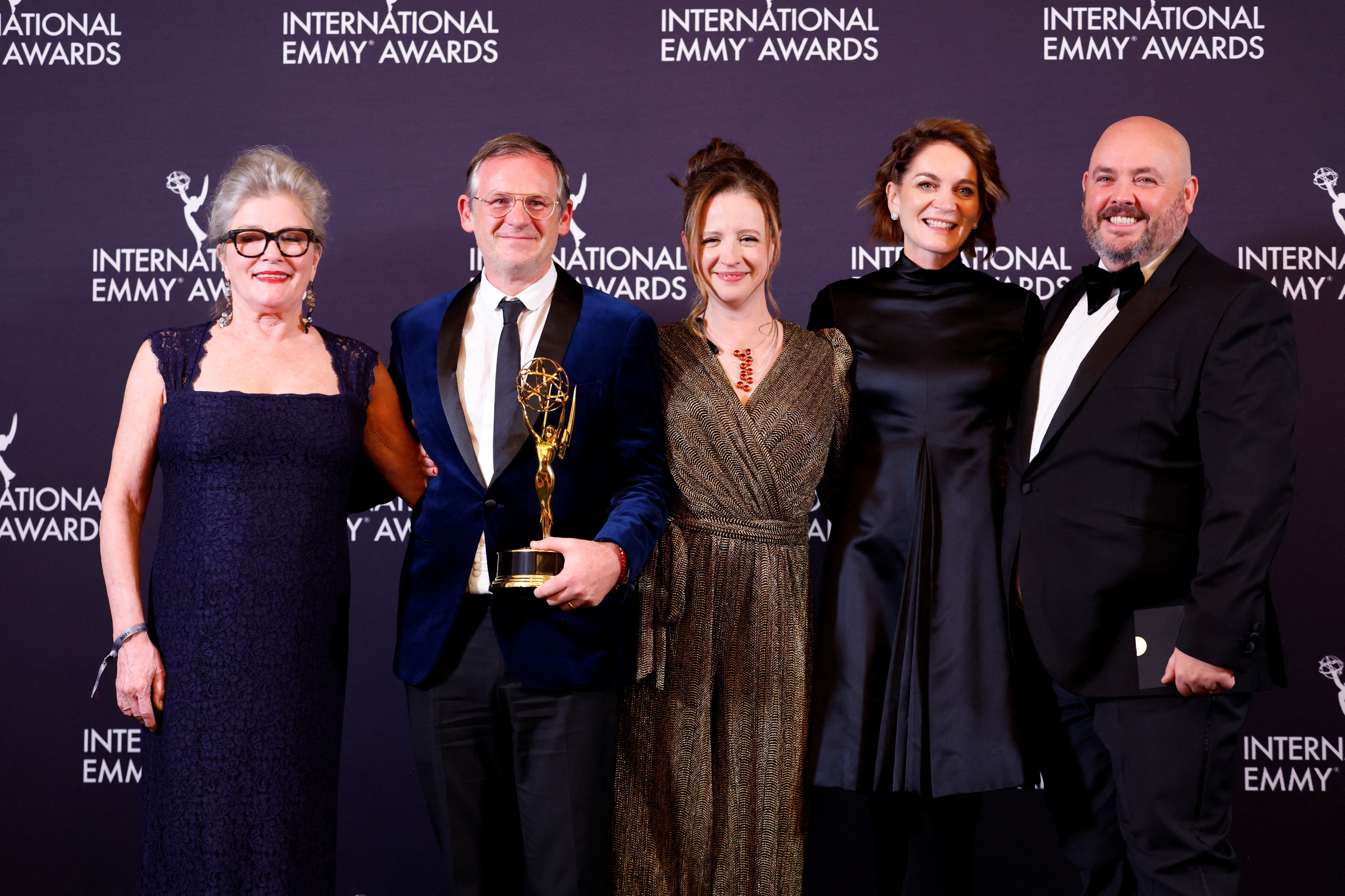 Dominic Treadwell-Collins and team pose with the Best Drama Series Award for 'Rivals' during the 2025 International Emmy Awards