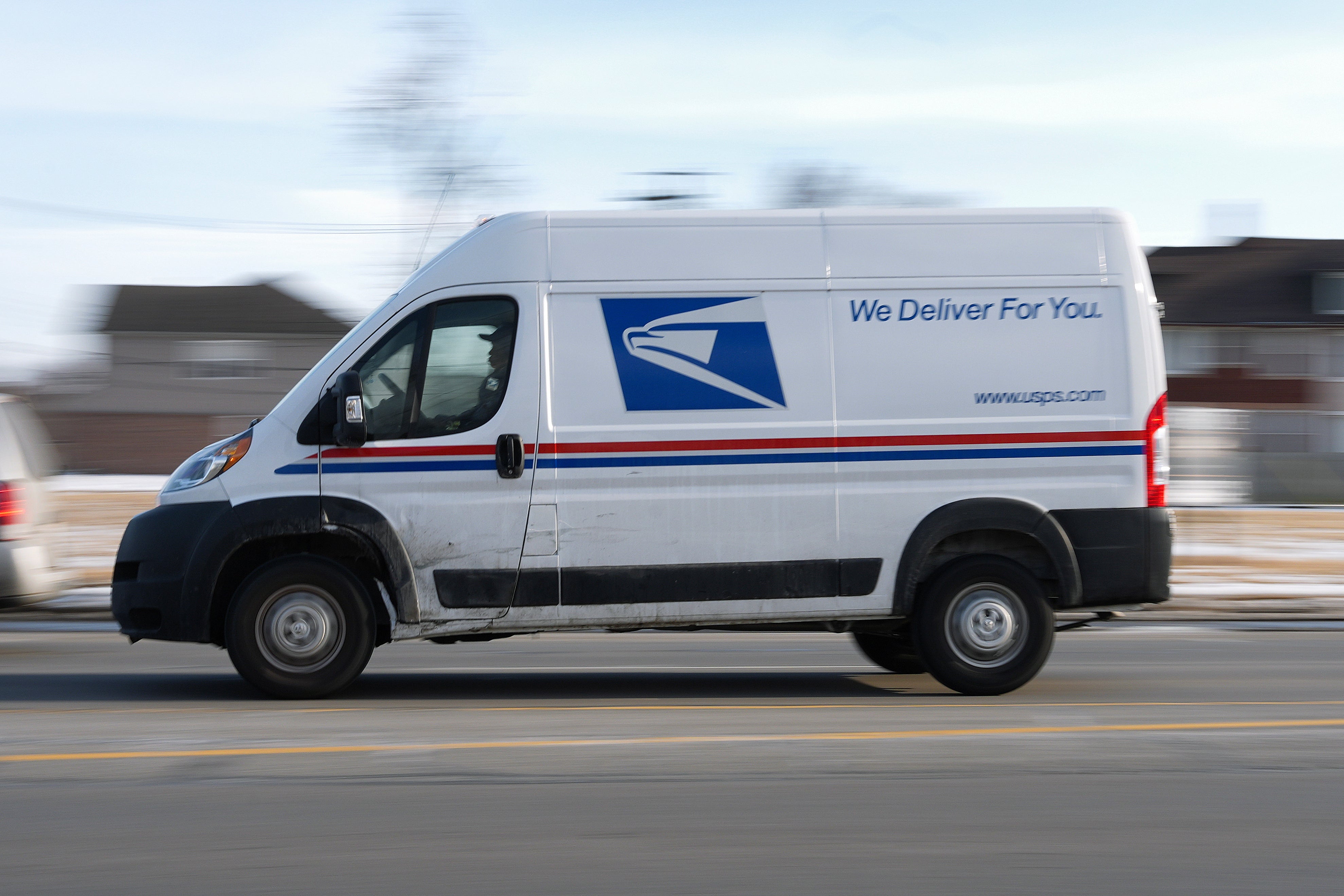 A United States Postal Service truck drives through Detroit, Feb. 24, 2025