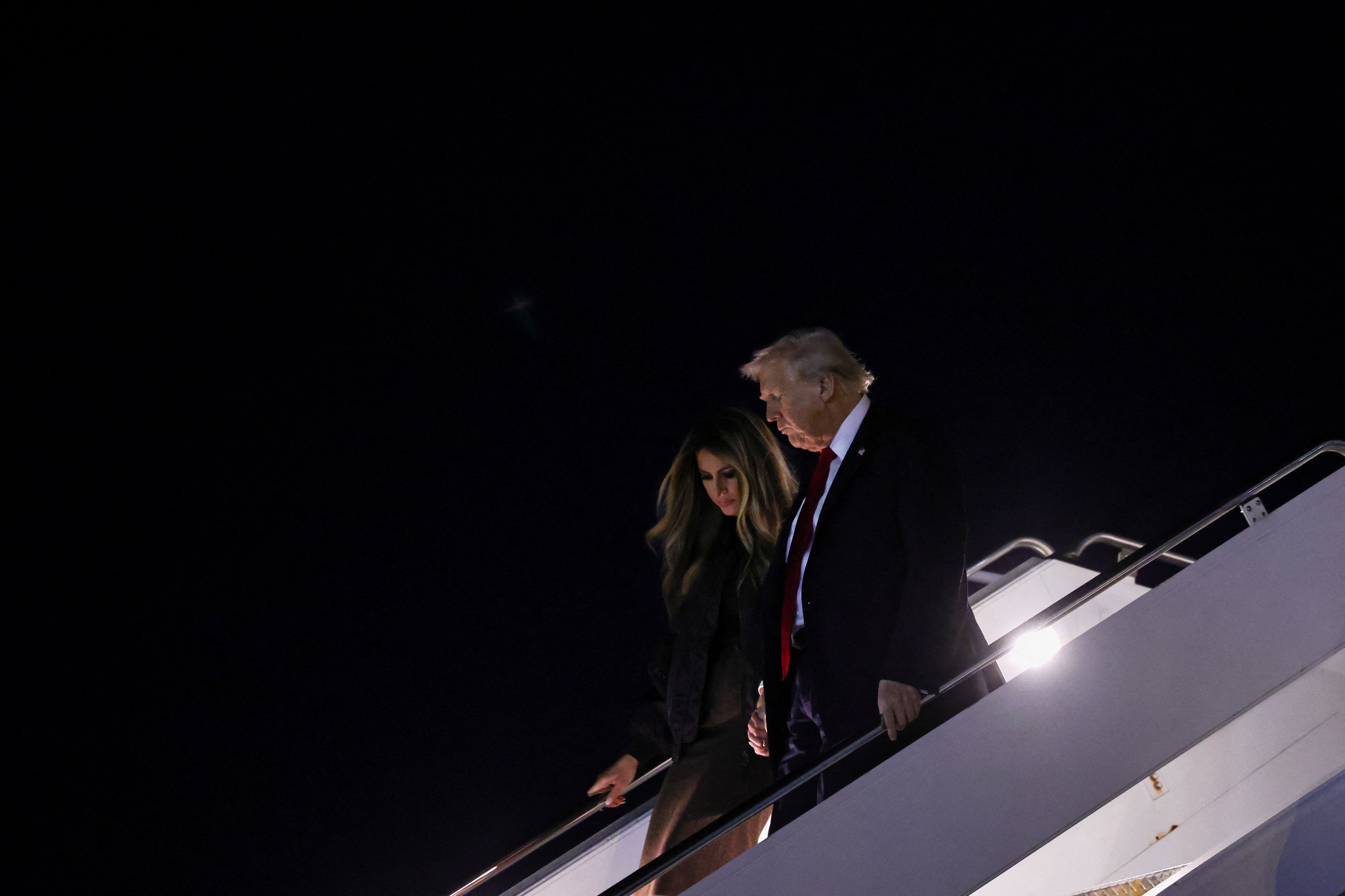 President Donald Trump and first lady Melania Trump deplane as they arrive at Palm Beach International Airport in West Palm Beach, Florida, U.S., November 25, 2025. REUTERS/Anna Rose Layden