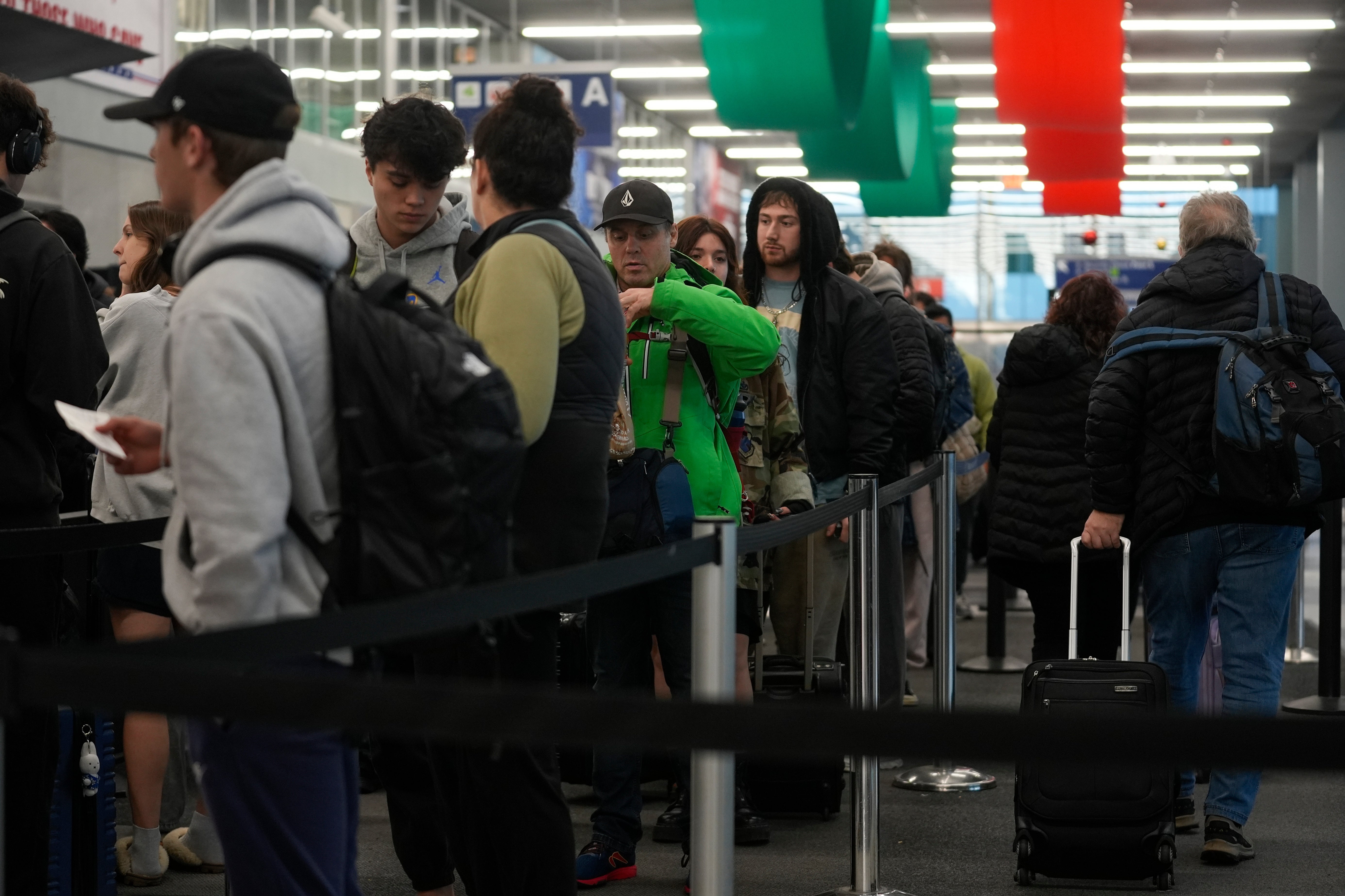 Holiday travelers gather at Chicago’s O'Hare International Airport on Wednesday in Illinois. Hundreds of flights were delayed at the Midwest travel hub