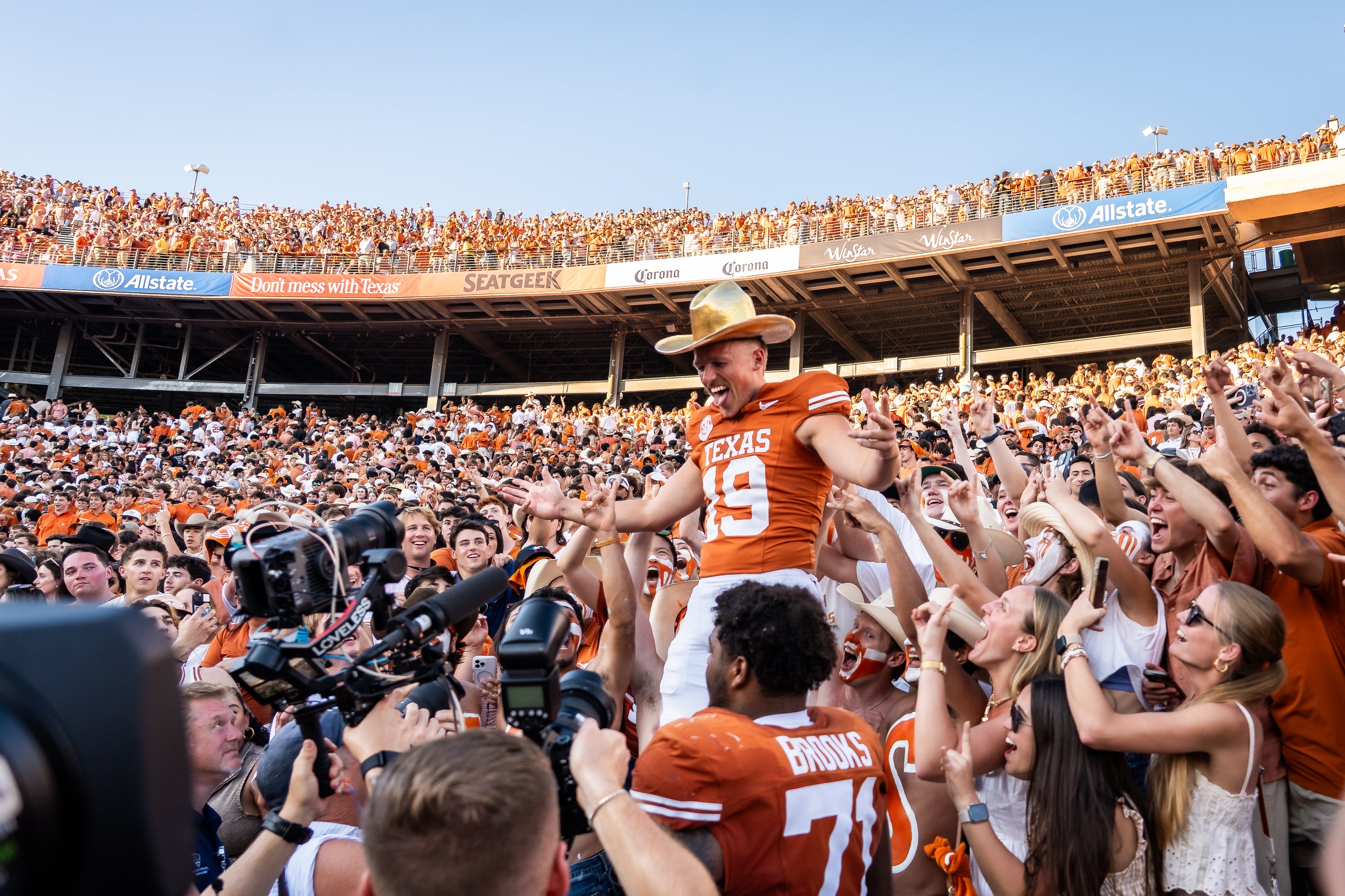 Texas punter Jack Bouwmeester (19) celebrates with the Golden Hat after defeating Oklahoma in an NCAA college football game at the Cotton Bowl in Dallas, Saturday, Oct. 11, 2025