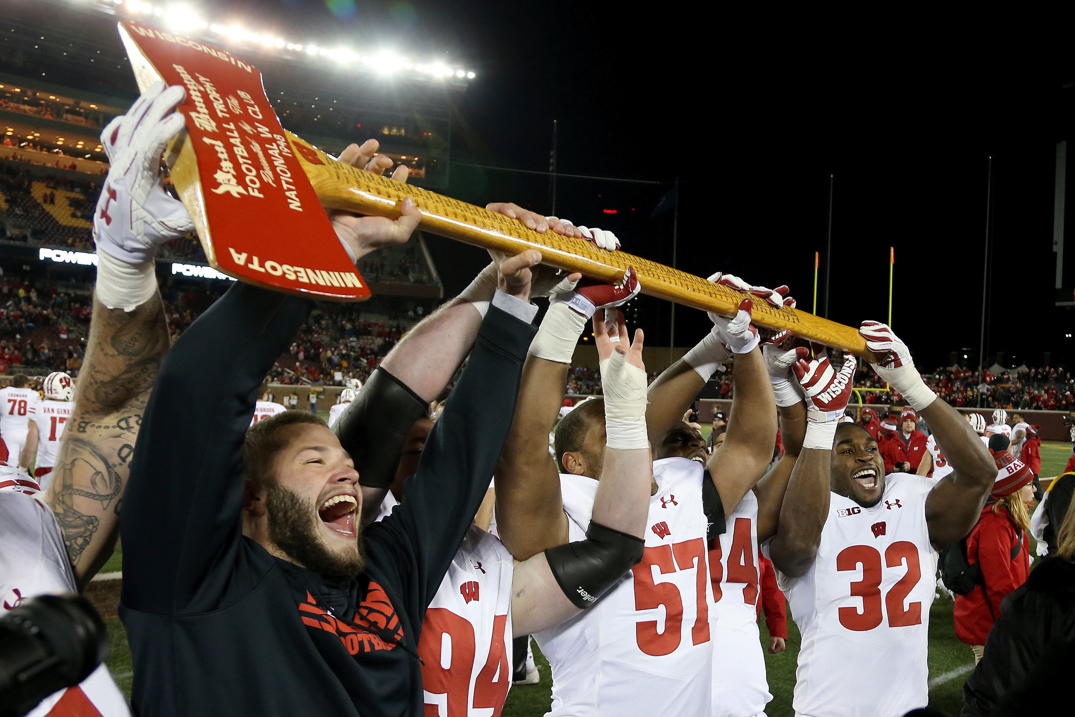 In this Nov. 25, 2017, file photo, Wisconsin players hold up Paul Bunyan's Axe up after winning 31-0 against Minnesota in an NCAA college football game in Minneapolis