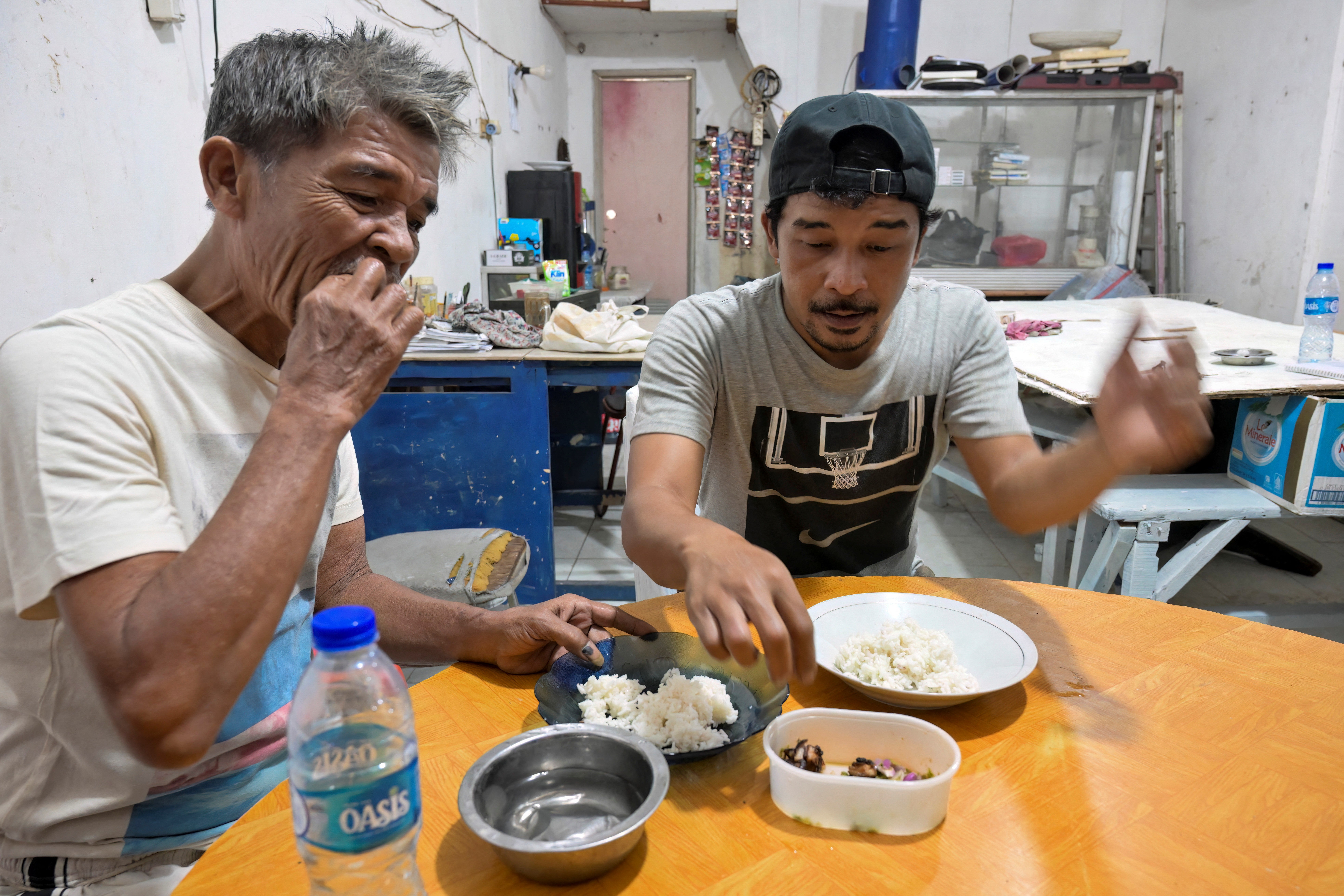 Dog meat enthusiasts enjoy a dish at a food stall in Jakarta
