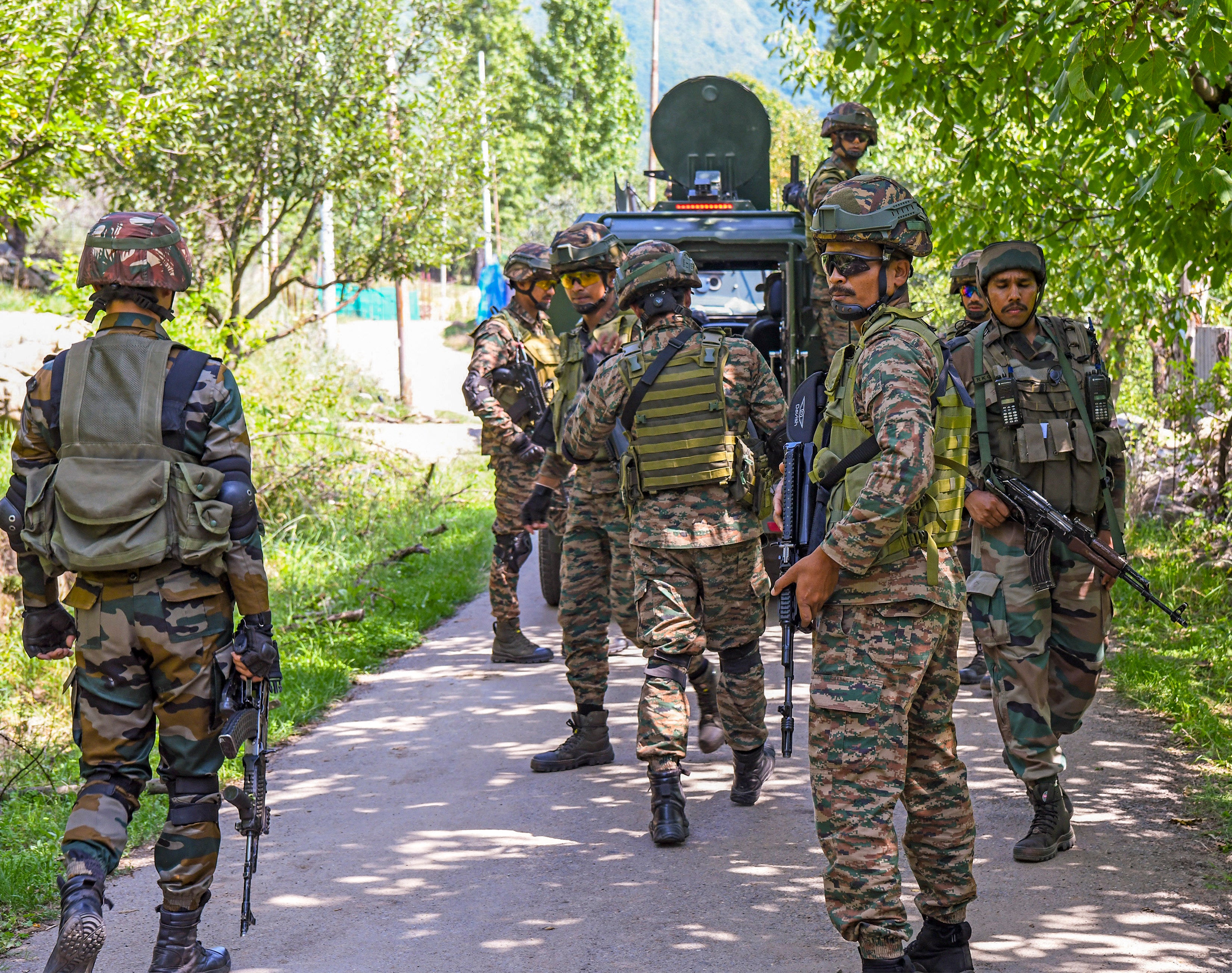 Army personnel stand guard and security forces patrol near the Lidwas Meadows of Dara, Kashmir, on 28 July 2025